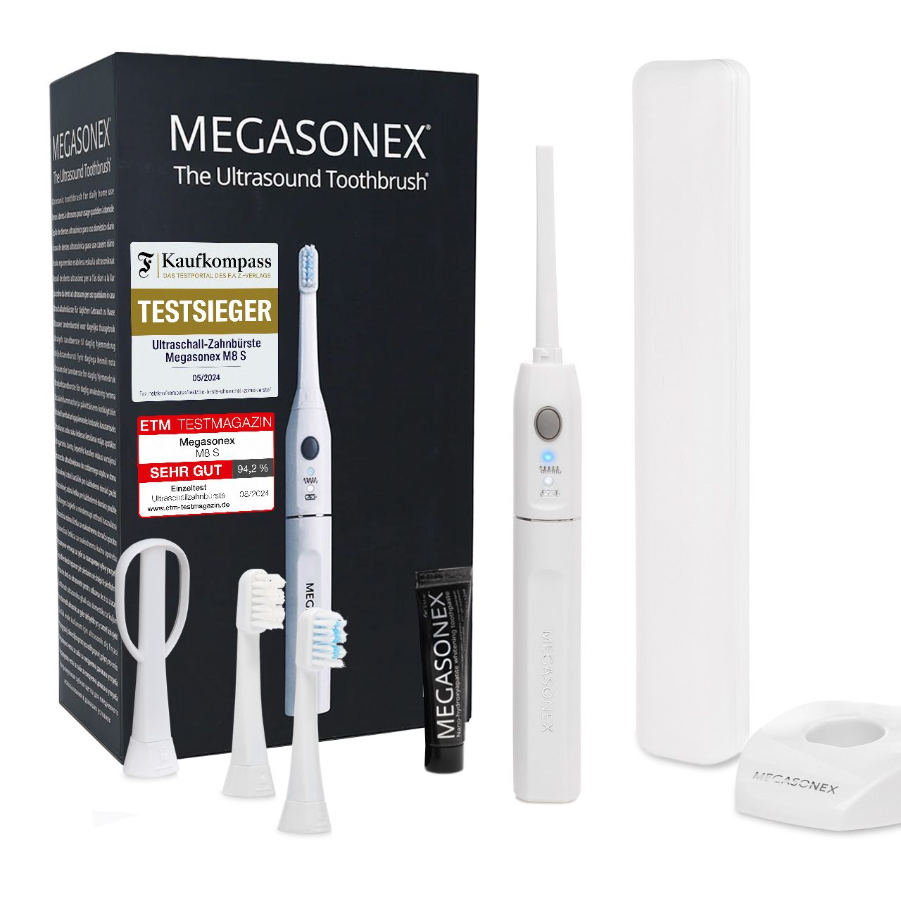 Zahnbürste, Zubehör und Verpackung. Enthält Zahnbürste, Aufsätze, Zungenreiniger, Zahnpasta, Ladestation und Reiseetui. Testsiegel.