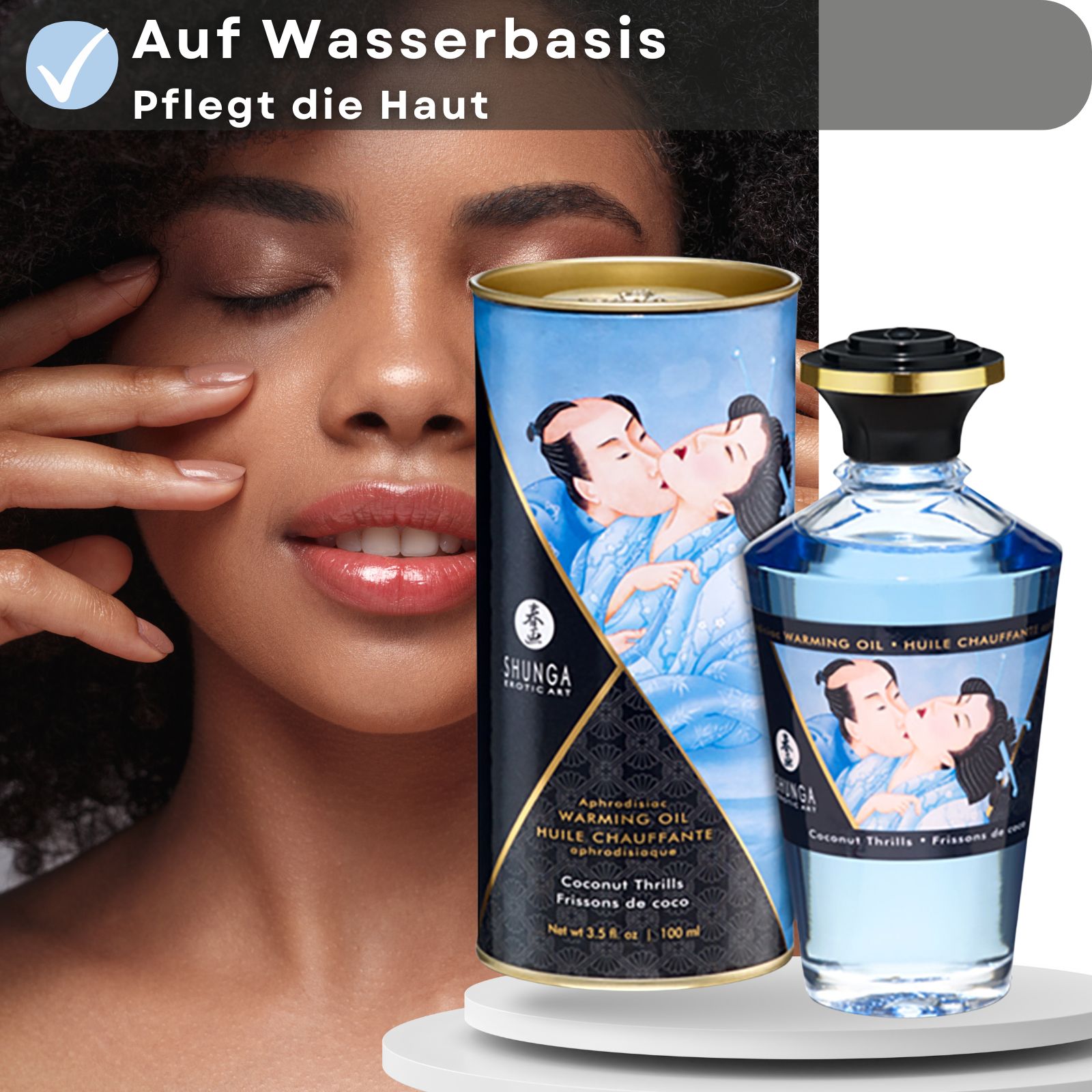 Zylindrische Dose und Flasche mit blauem Öl. Aufschrift: Shunga, Warming Oil, Coconut Thrills. Frau berührt Gesicht.