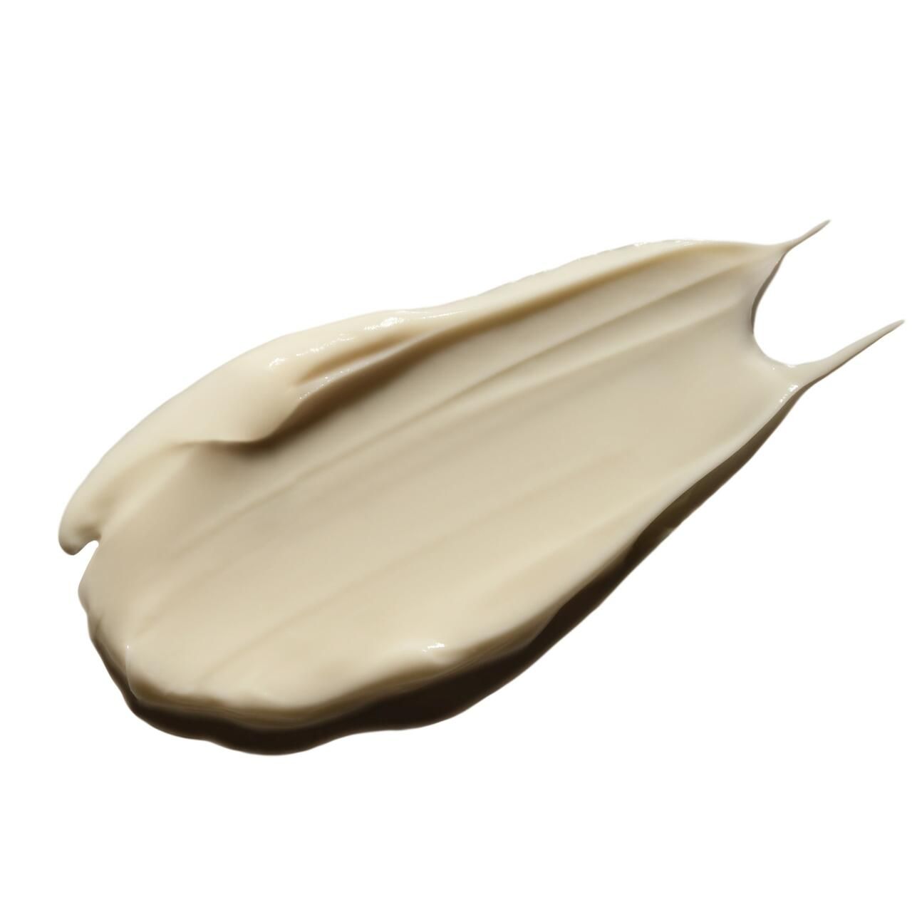 Creme-Abstrich auf weißem Hintergrund. Creme-Textur, hellbeige. Form: länglich, mit Spitze.