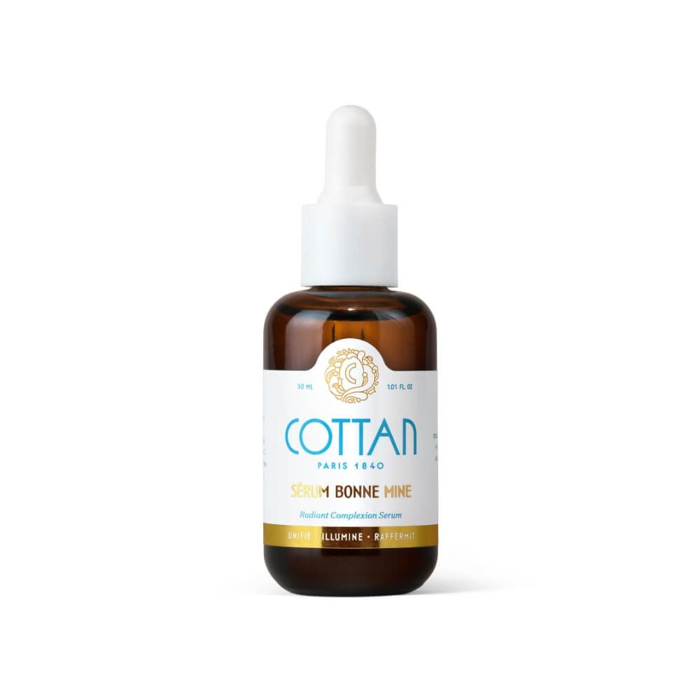 Braune Glasflasche mit weißem Tropfer. Aufschrift: COTTAN, Serum Bonne Mine. Goldener Streifen am Boden.