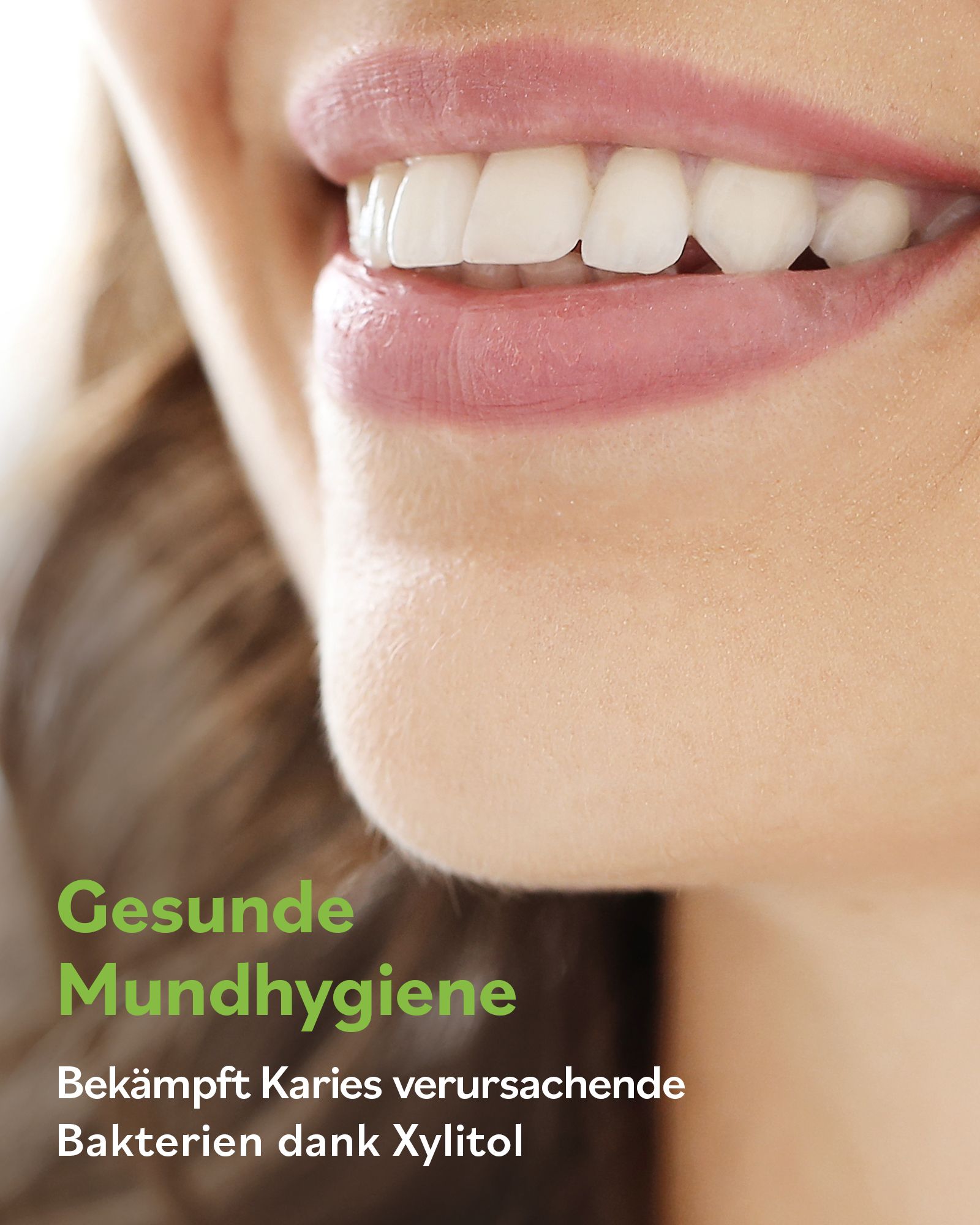 Nahaufnahme eines Lächelns mit weißen Zähnen. Text: Gesunde Mundhygiene. Bekämpft Karies verursachende Bakterien dank Xylitol.
