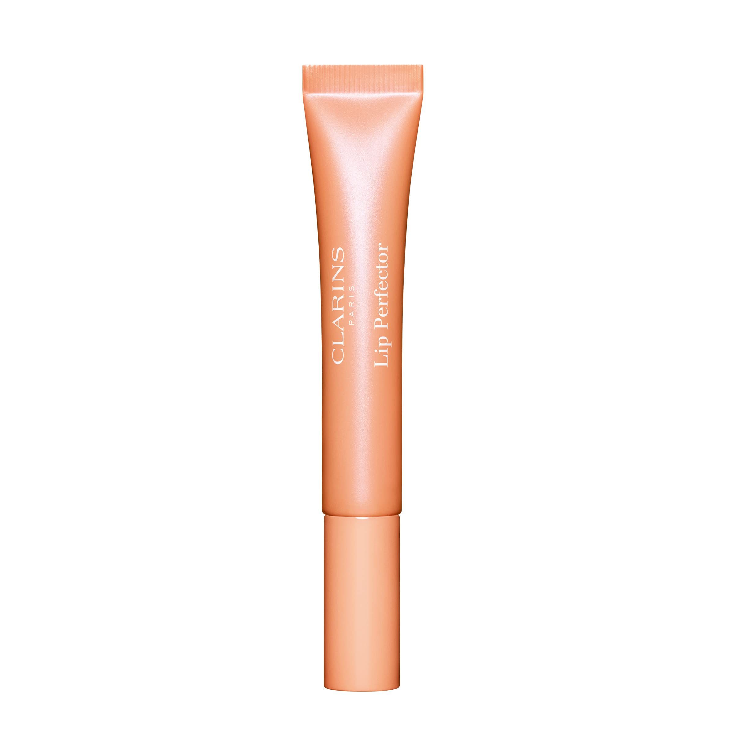 Clarins Lip Perfector in Pfirsich-Farbe. Tube mit Schraubverschluss. Aufschrift Clarins Paris und Lip Perfector.