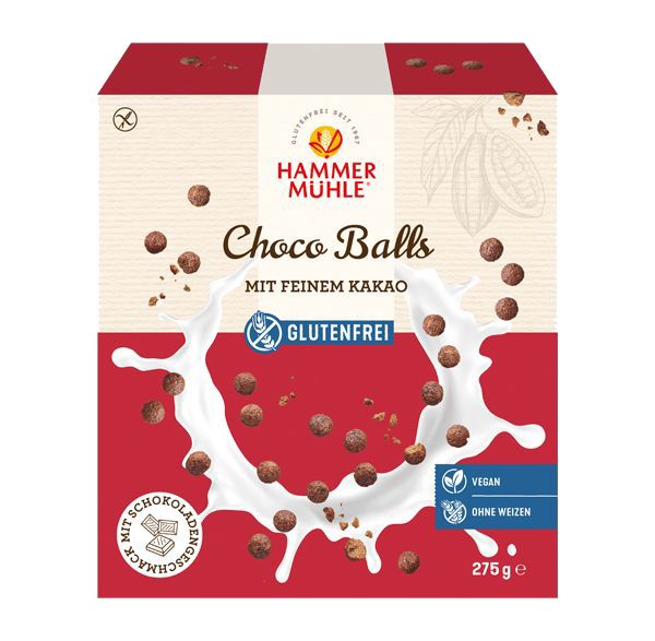 Verpackung von Choco Balls. Rote und weiße Box mit Produktnamen, Logo und Aufschrift "Glutenfrei". Abbildung von Choco Balls und Milch.