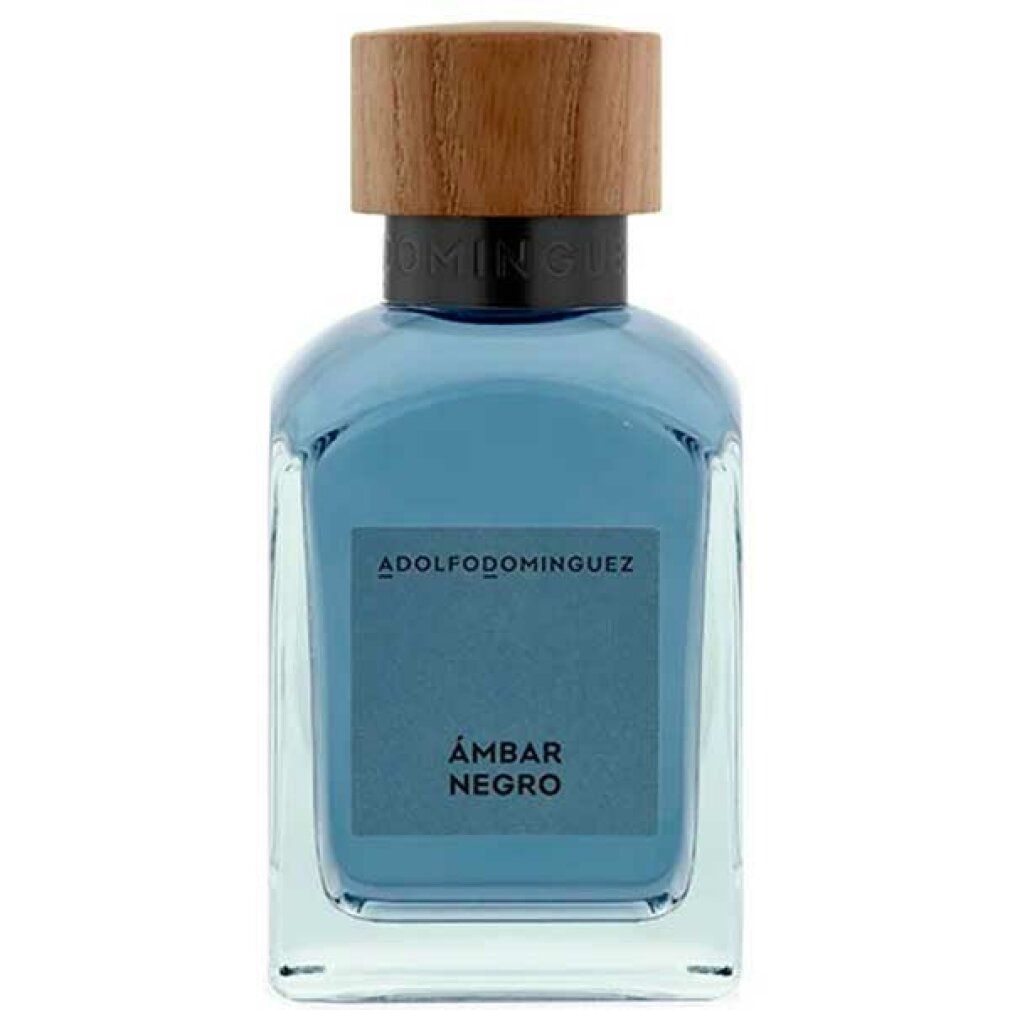 Glasflakon mit Holzdeckel. Aufschrift: ADOLFODOMINGUEZ, ÁMBAR NEGRO. Blaue Flüssigkeit sichtbar.