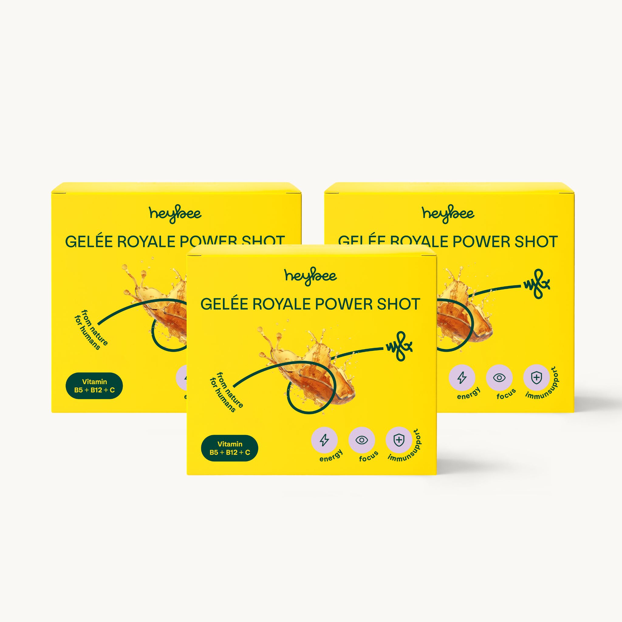 Drei Packungen heybee Gelée Royale Power Shot. Gelbe Verpackung mit Produktnamen und Logo. Vitamin B5+B12, Energie, Fokus.