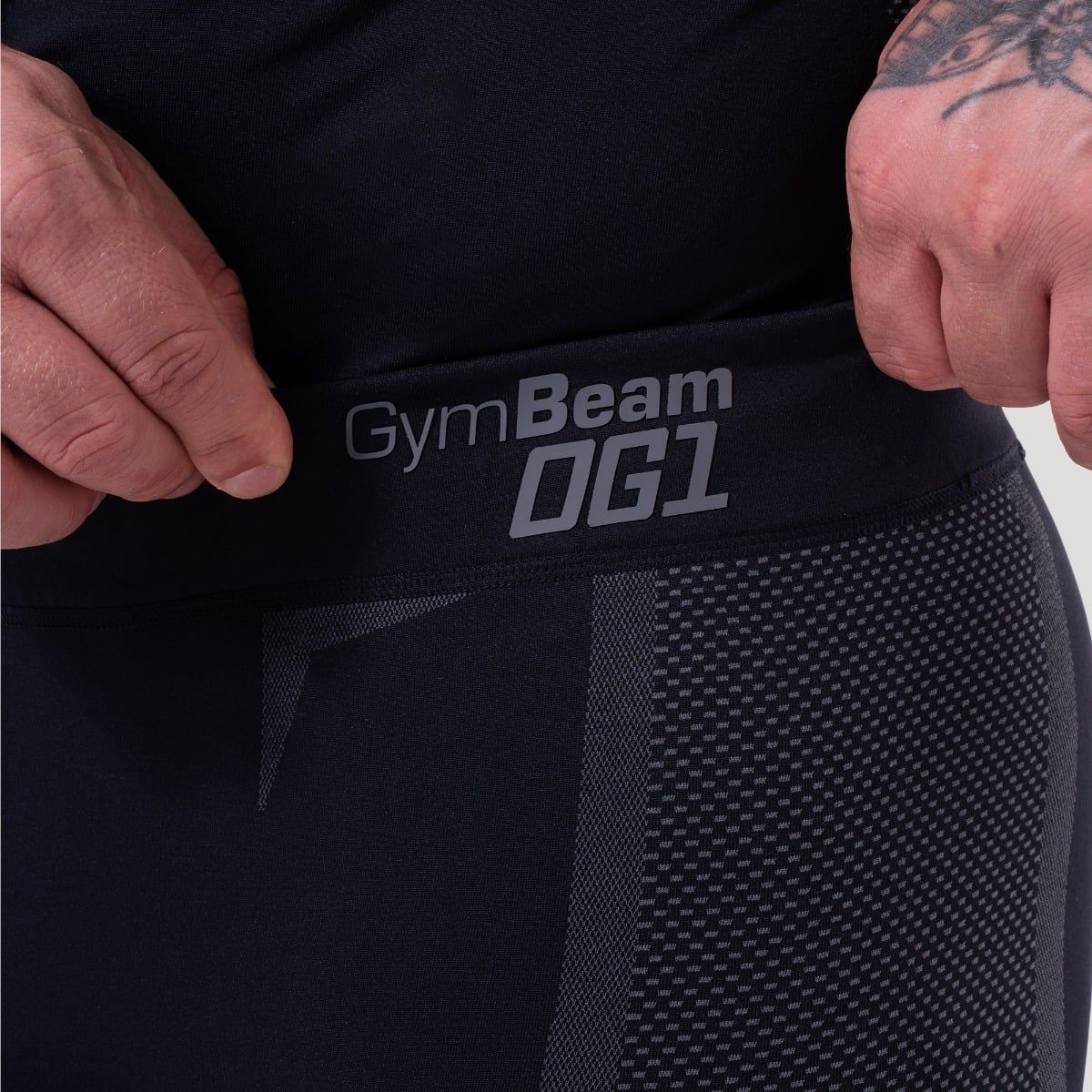 Nahaufnahme des Bundes einer schwarzen Herren-Leggings mit dem GymBeam-Logo und nahtlosem Design.