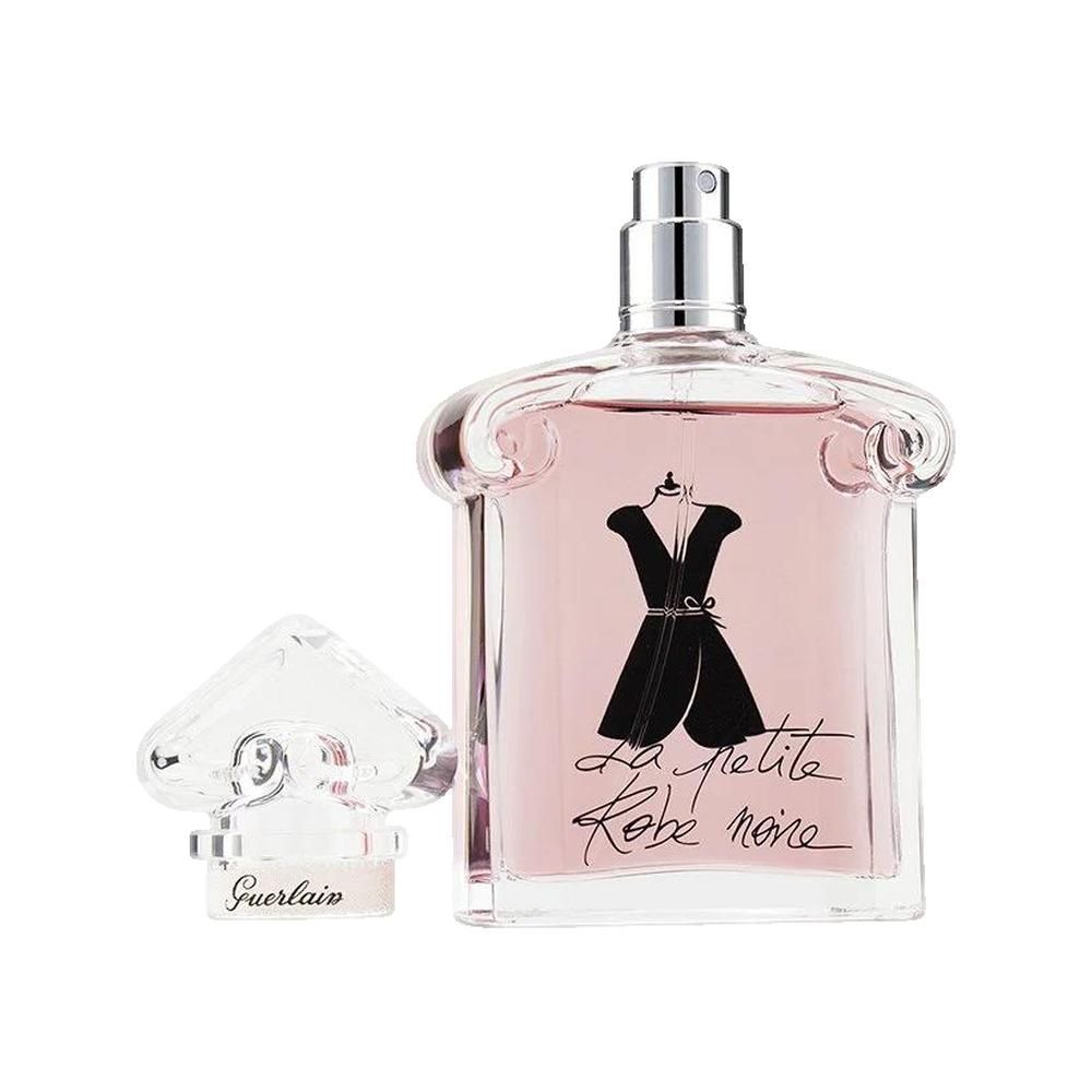 Guerlain-Flakon mit rosa Flüssigkeit und schwarzem Kleid-Design. Transparenter Verschluss daneben. Silberner Zerstäuber.