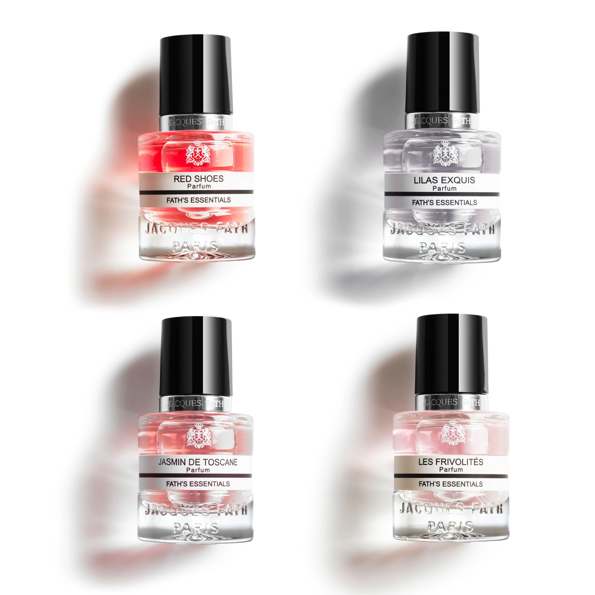 Vier kleine Parfumflakons mit schwarzen Kappen. Aufschrift: Fath's Essentials. Verschiedene Düfte, farbige Flüssigkeiten.