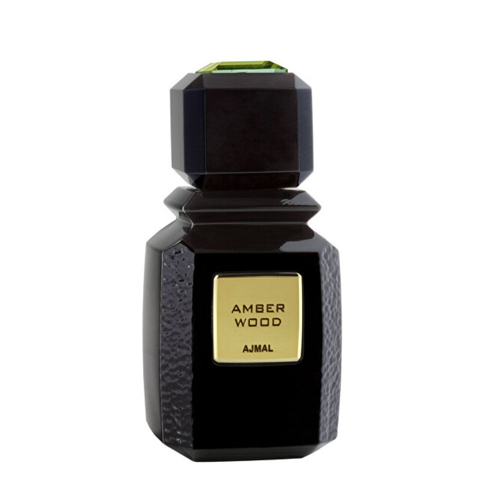 Schwarze Flasche mit goldfarbenem Etikett AMBER WOOD und AJMAL. Eckiger Deckel mit grüner Verzierung.