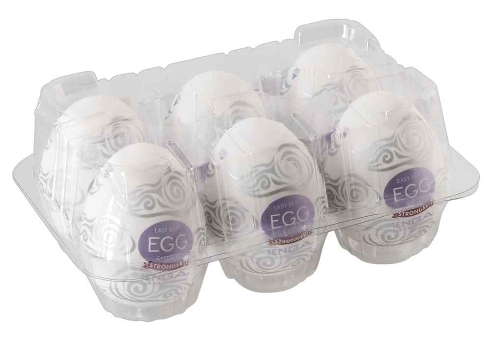 Sechs Ei-förmige Produkte in einer transparenten Verpackung. Wolkenmuster und 'EGG' sichtbar. 'TENGA' und 'STRONGER!' Banner.