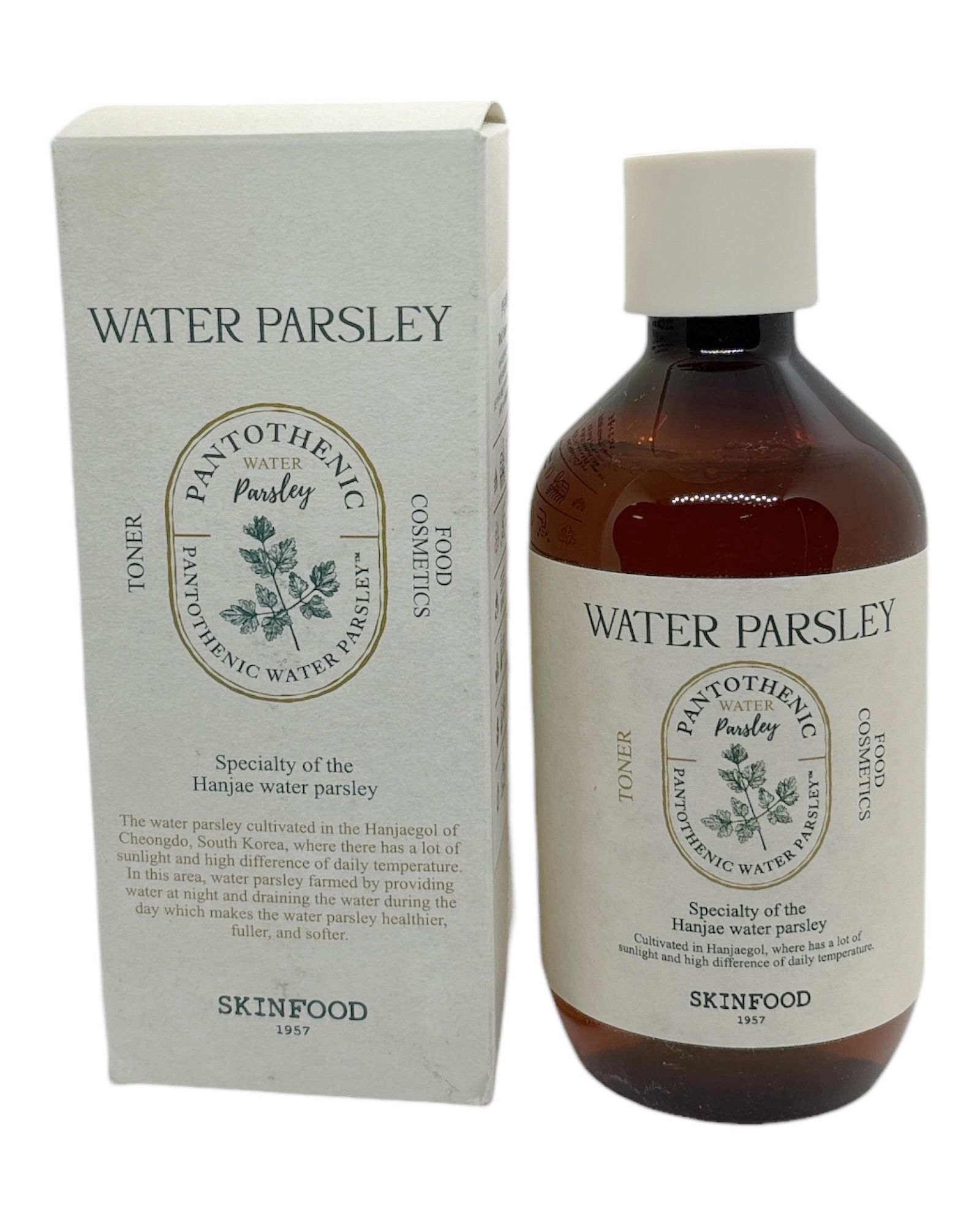 Braune Flasche und Karton mit Aufschrift 'WATER PARSLEY'. Toner von SKINFOOD. Text auf Englisch.