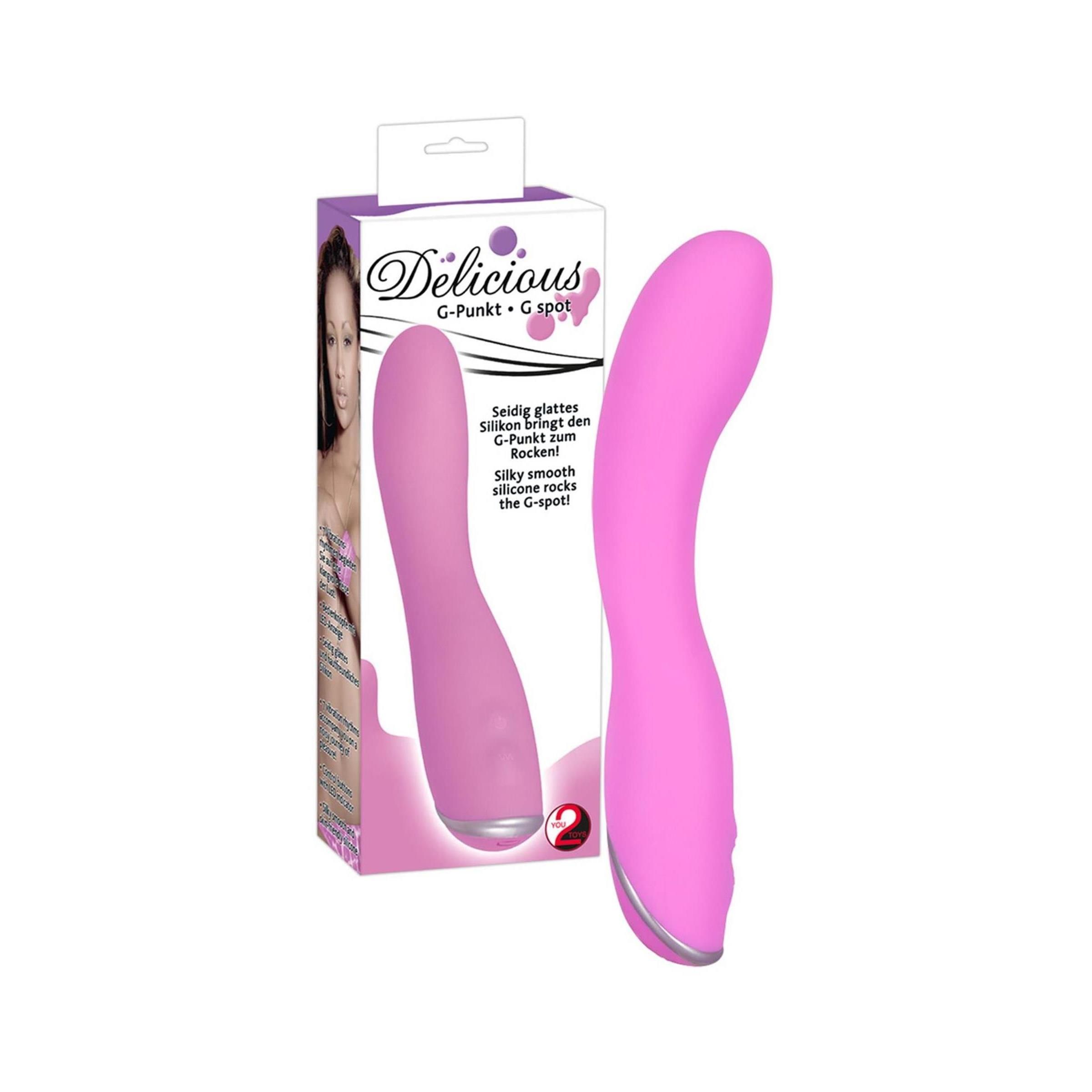 Rosa Vibrator in Verpackung. Aufdruck: Delicious, G-Punkt + G-Spot. Abgebildet: Produkt und Frau.