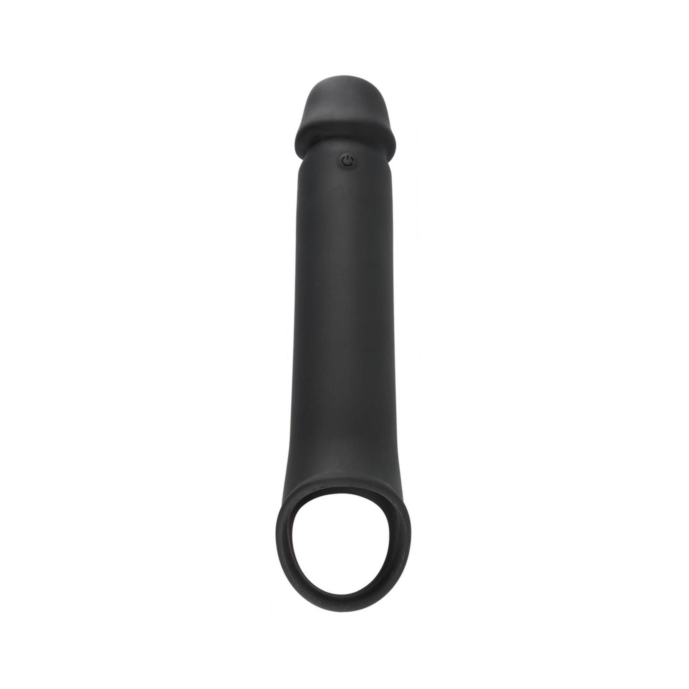 Schwarze Penishülle mit Hodenring. Die Hülle hat eine längliche Form mit einem Ring am Ende. Ein Knopf ist sichtbar.