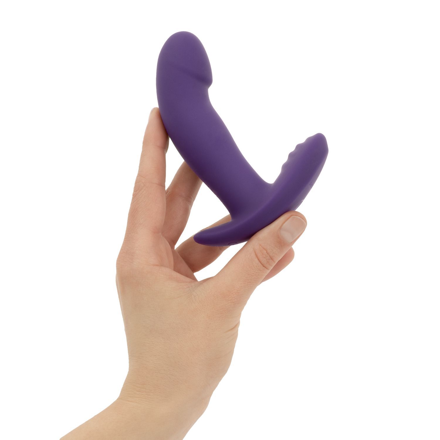 Lila Vibrator, von Hand gehalten. Form mit erhabenen Elementen. Sichtbare Details.