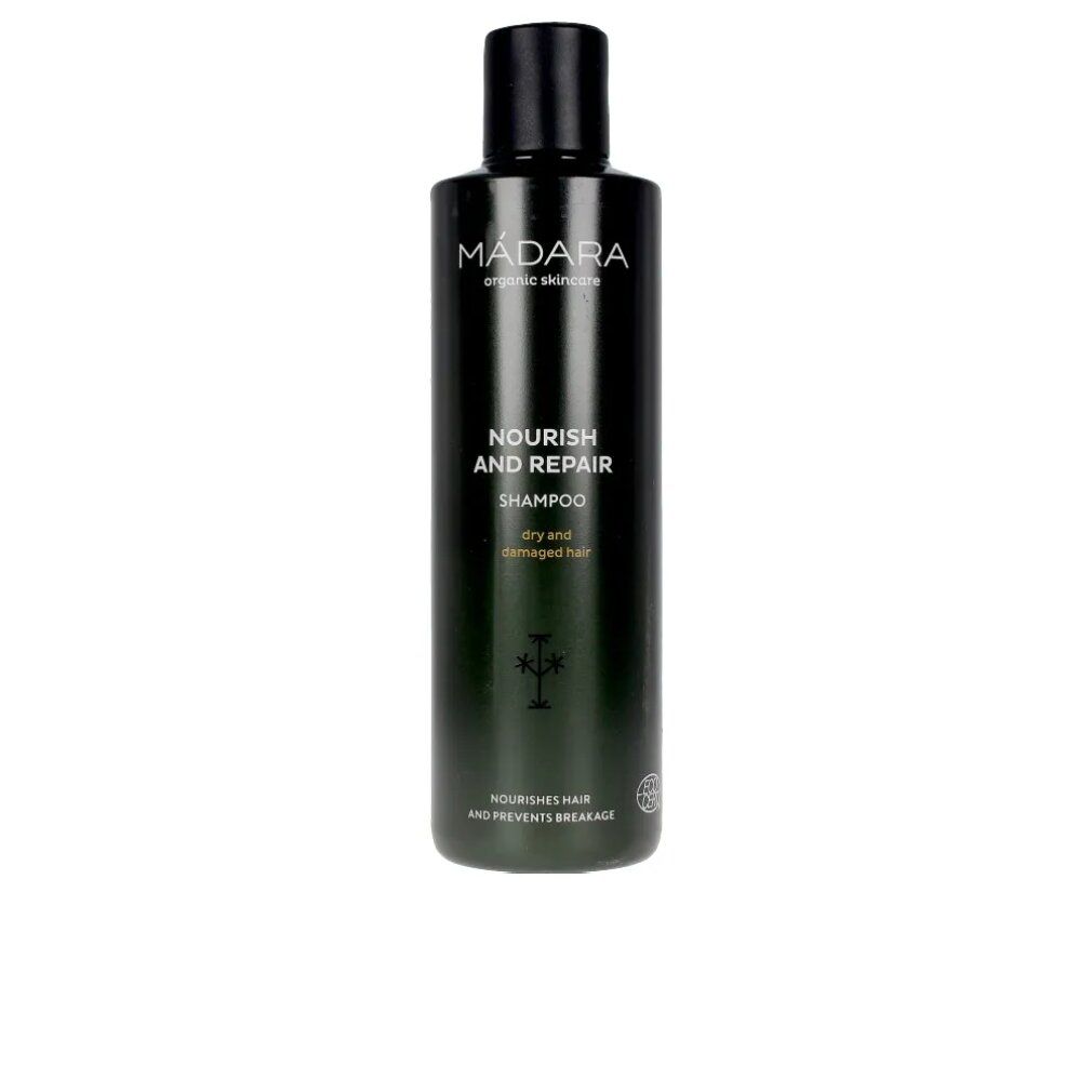 Dunkelgrüne Shampoo-Flasche mit schwarzem Deckel. Aufschrift: MÁDARA, Nourish and Repair Shampoo, für trockenes und strapaziertes Haar.