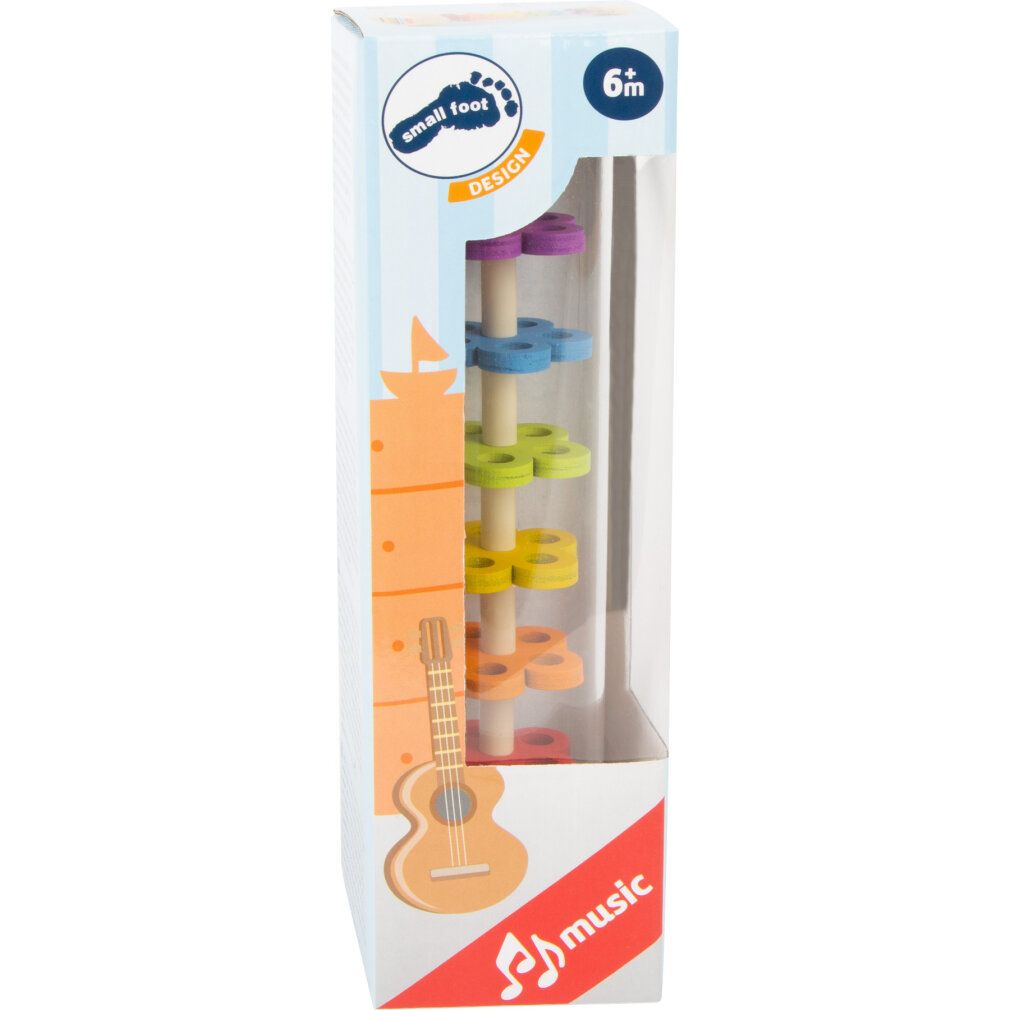 Verpackung mit zylindrischem Spielzeug. Auf der Verpackung: Logo, Gitarren-Illustration, Text 'music' und Altersempfehlung '6m'.