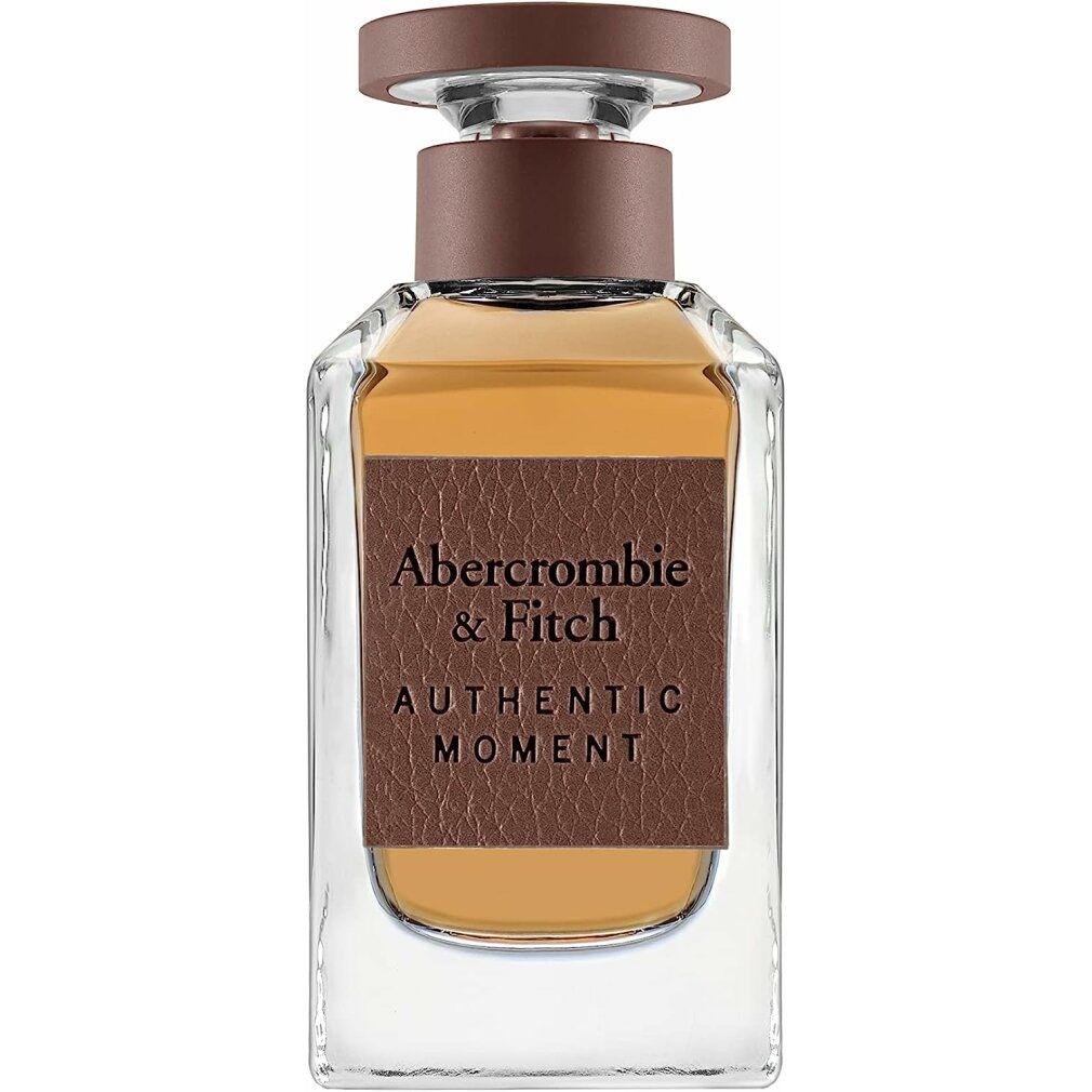 Parfümflakon mit braunem Verschluss und Etikett. Aufschrift: Abercrombie & Fitch, Authentic Moment.