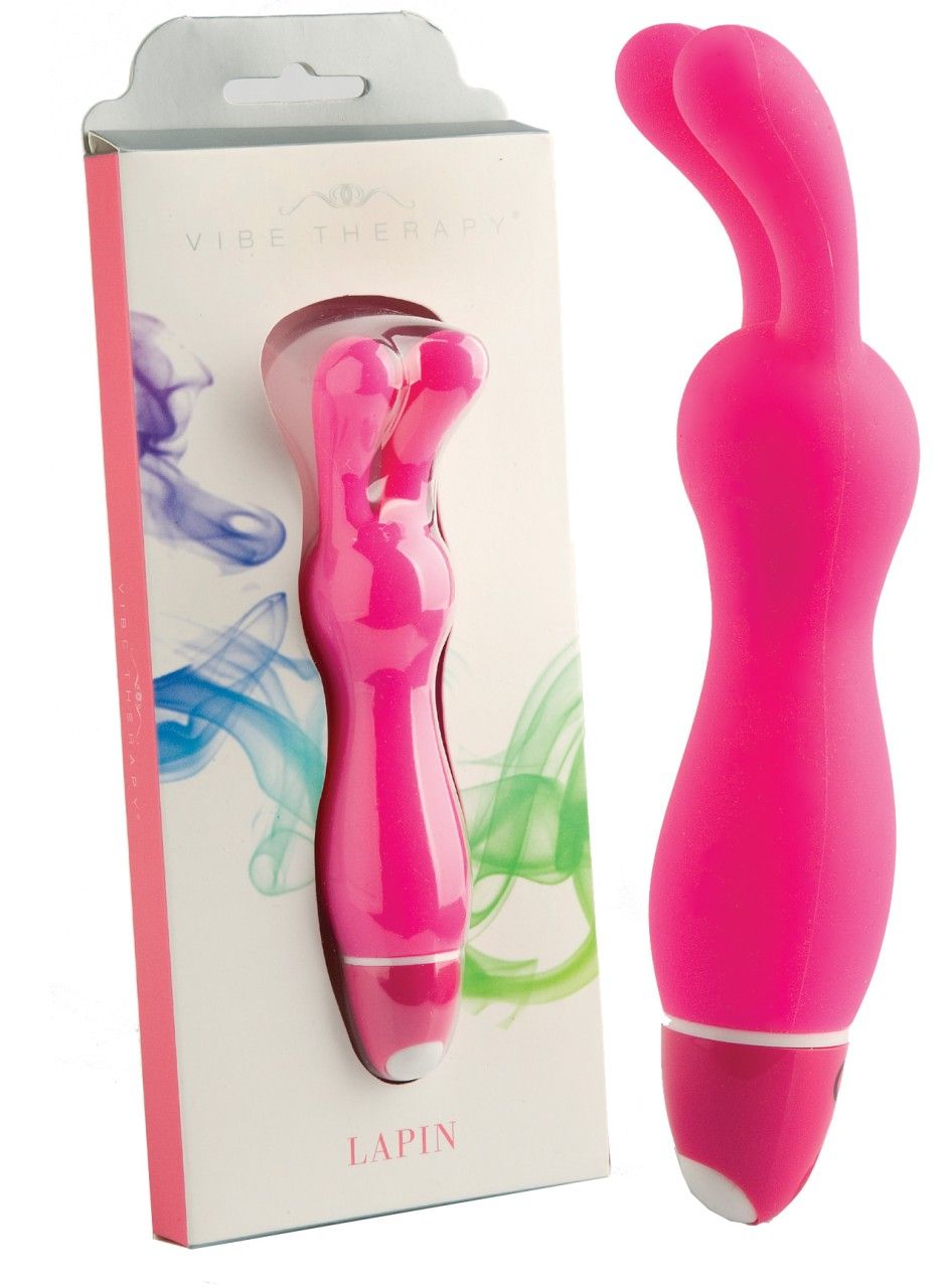 Pinkfarbener Vibrator und Verpackung. Verpackung mit Text 'Vibe Therapy' und 'lapin'.