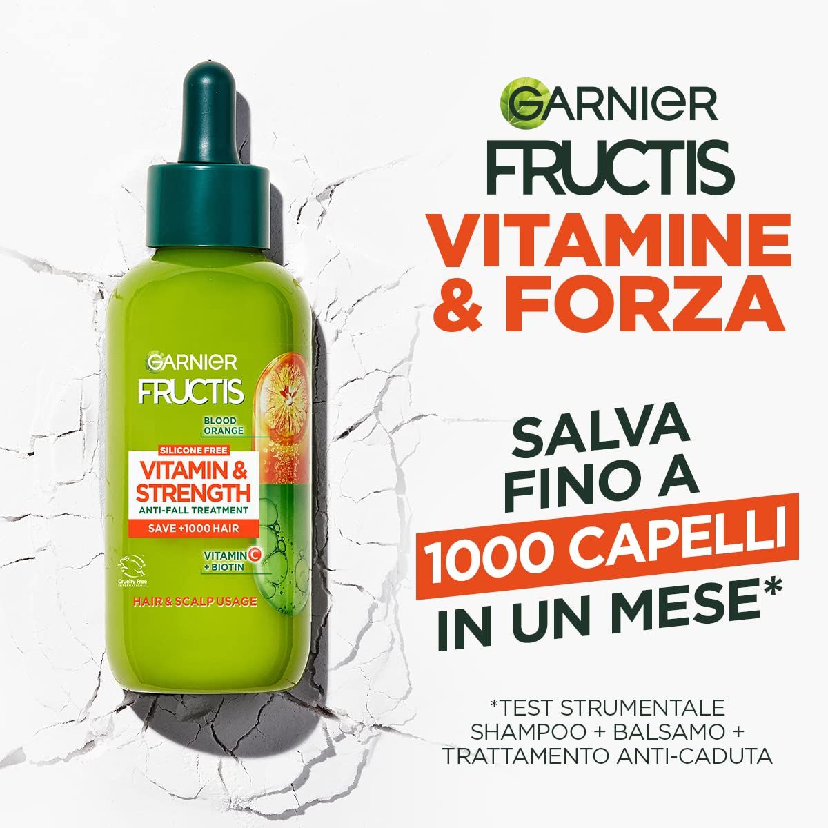 Grüne Flasche mit Tropfer. Aufschrift: Garnier Fructis Vitamine & Kraft. Anti-Haarausfall-Behandlung. Spart bis zu 1000 Haare in einem Monat.