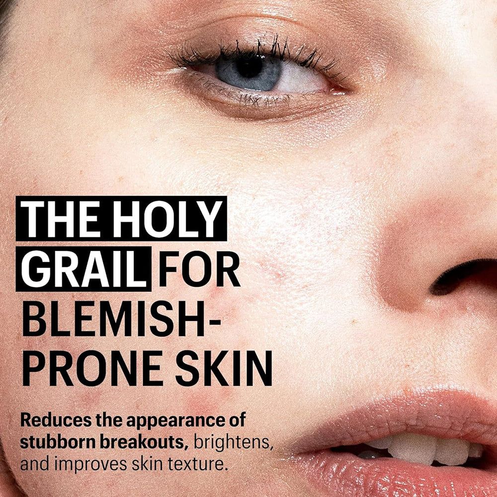 Nahaufnahme eines Gesichts mit Text: „THE HOLY GRAIL FOR BLEMISH-PRONE SKIN“. Text darunter: Reduziert Pickel, hellt auf.