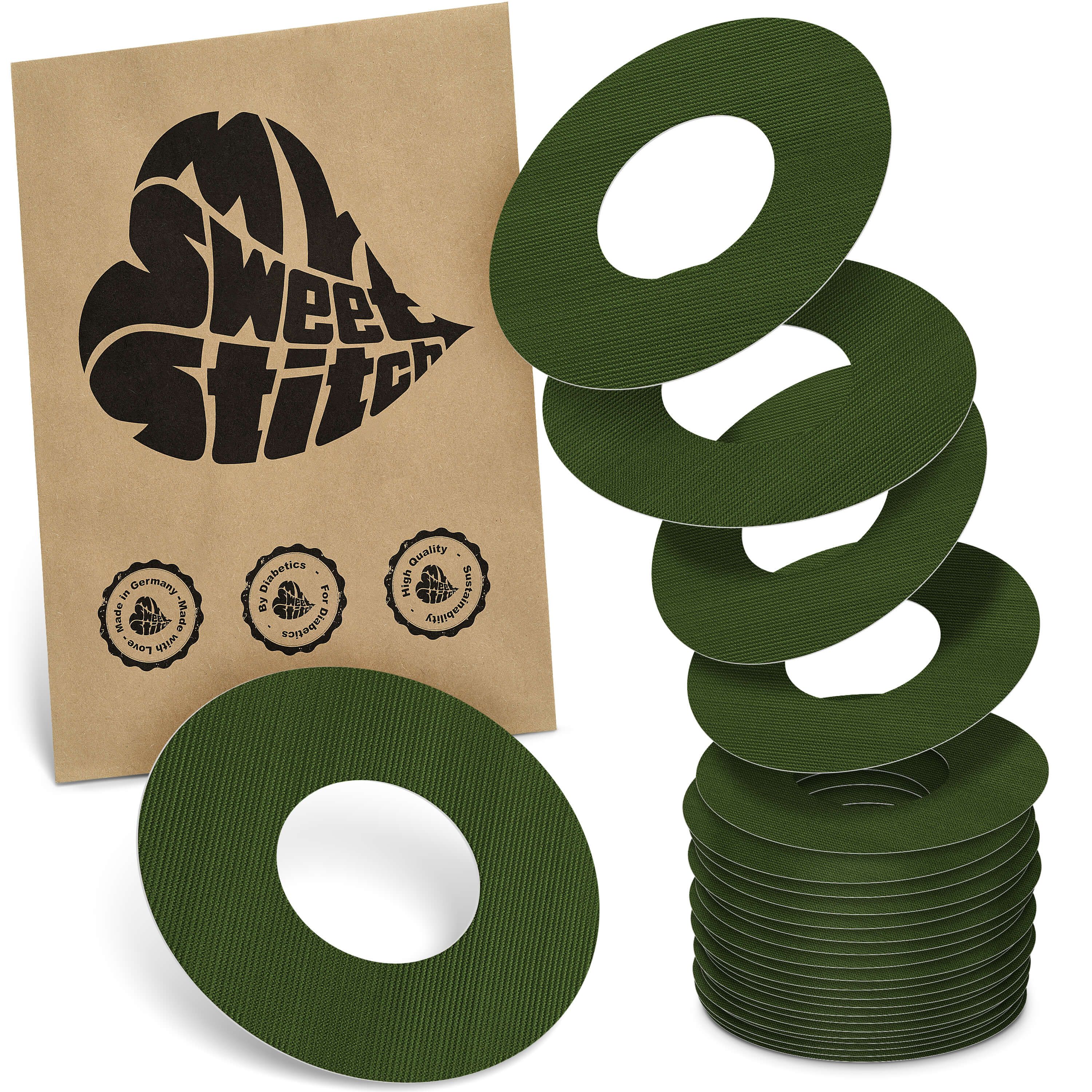 Grüne Ringpflaster mit zentralem Loch. Auf brauner Verpackung steht "MySweetStitch". Mehrere Pflaster sind gestapelt.