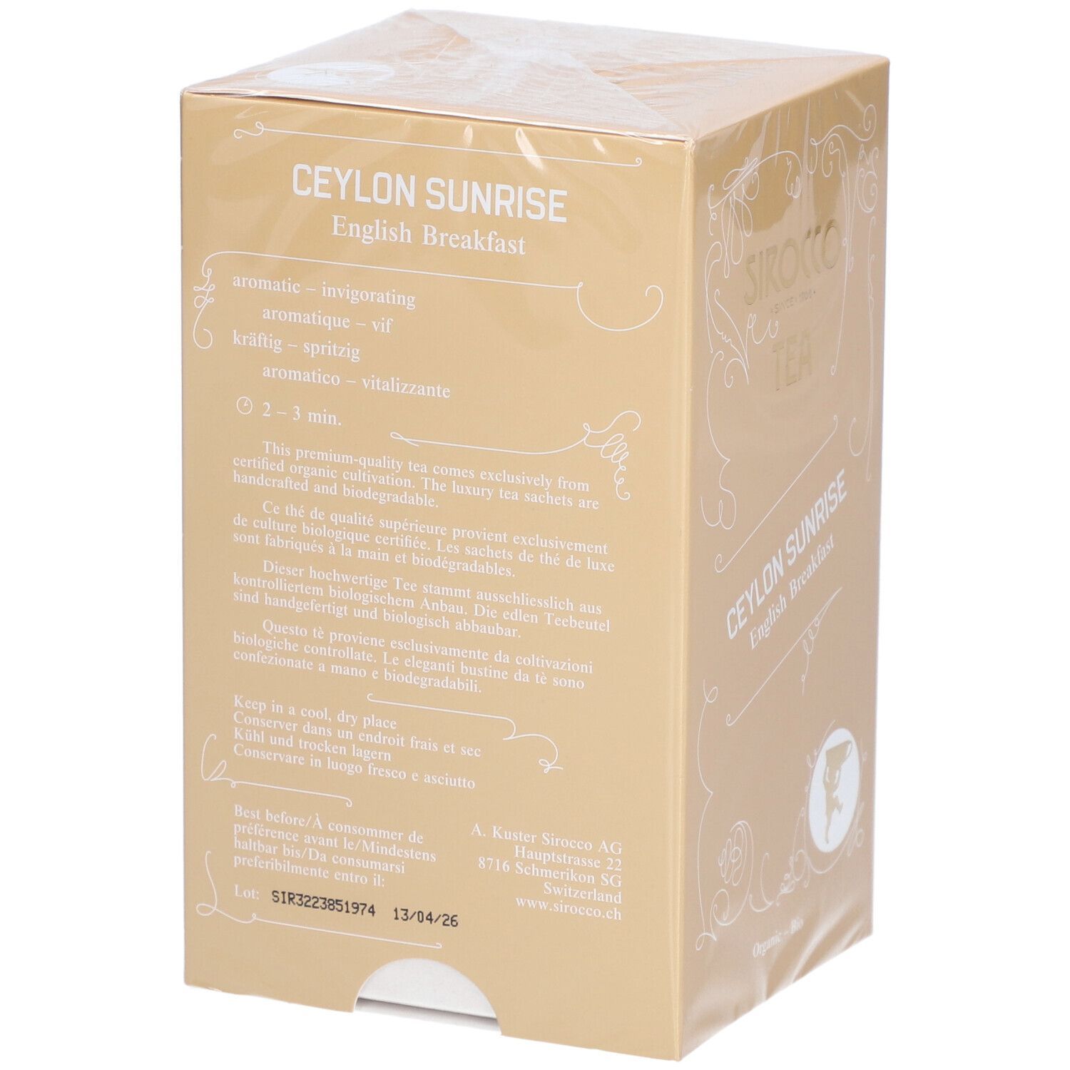 Rückseite der Tee-Verpackung. Produktname, Zubereitungshinweise und Haltbarkeitsdatum. Goldfarbener Karton.