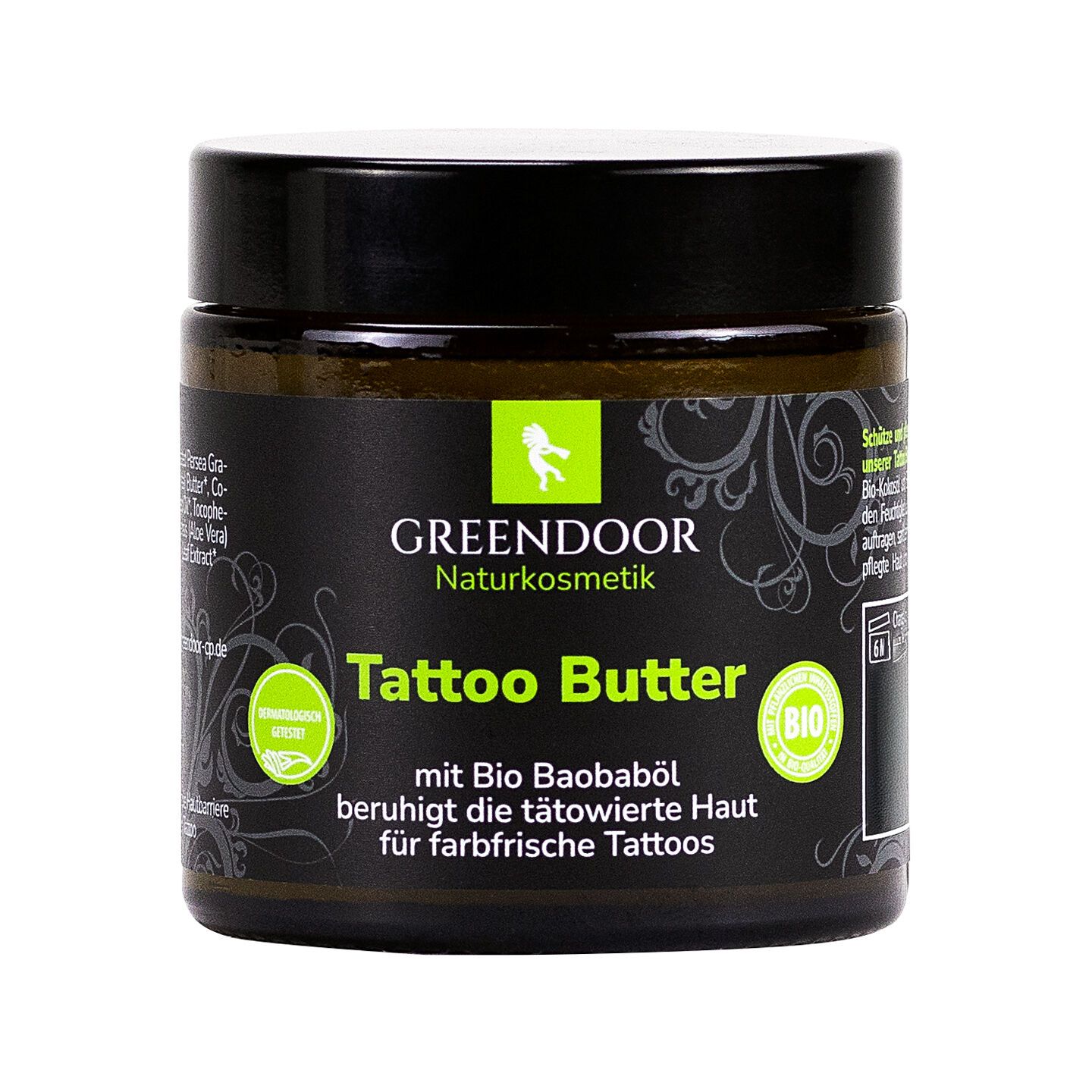 Glas mit schwarzem Deckel. Aufschrift: GREENDOOR Naturkosmetik, Tattoo Butter. Enthält Bio-Baobaböl. Bio-Siegel.