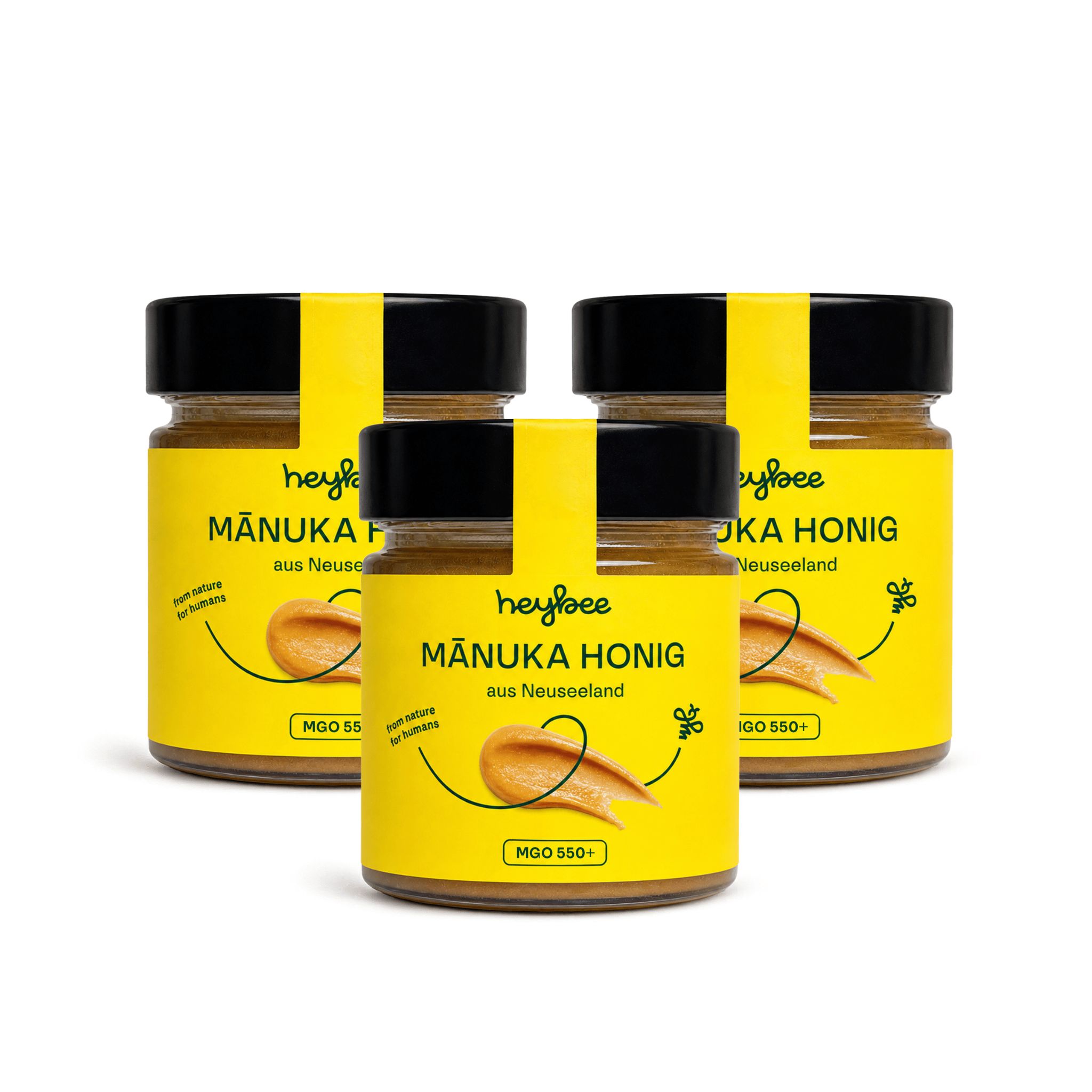 Drei Gläser Manuka Honig nebeneinander auf weißem Grund.
