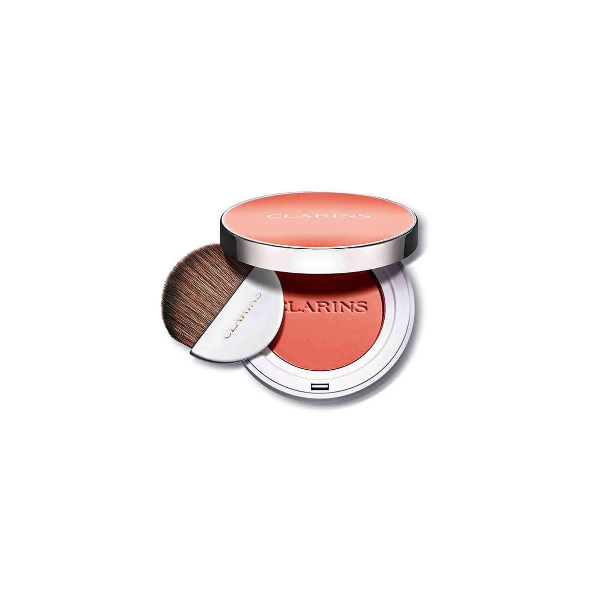 Clarins Joli Blush 07 Cheeky Peach. Runder Blush-Kompaktpuder mit Spiegel und Pinsel. Weißes Gehäuse, silberner Deckel. Pinsel mit Holzgriff.