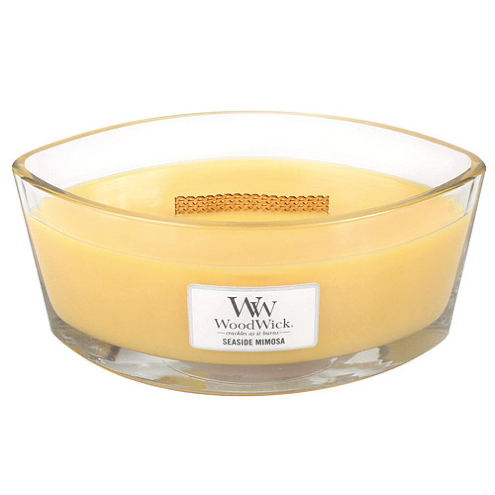 Ellipse-Kerze mit gelbem Wachs in Glasbehälter. Holzdocht. Etikett "WoodWick Seaside Mimosa".