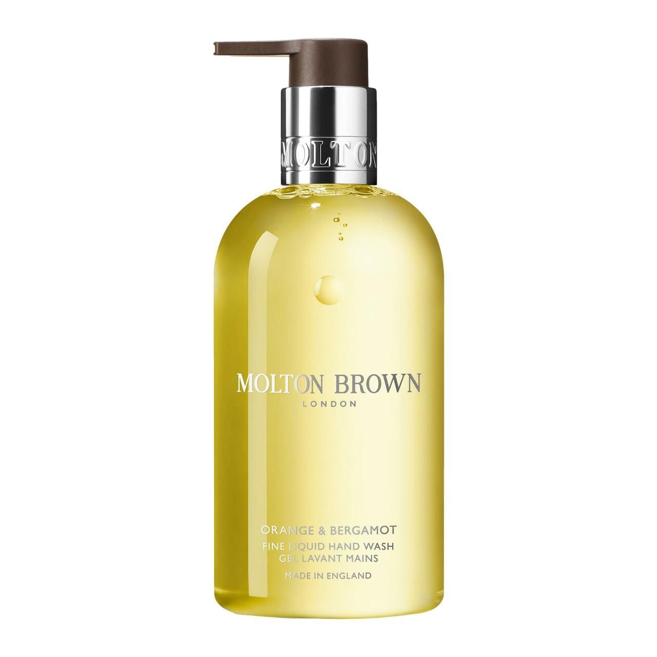 Gelbe Flüssigseife in einer Flasche mit Pumpe. Aufschrift: Molton Brown, Orange & Bergamot. Hergestellt in England.