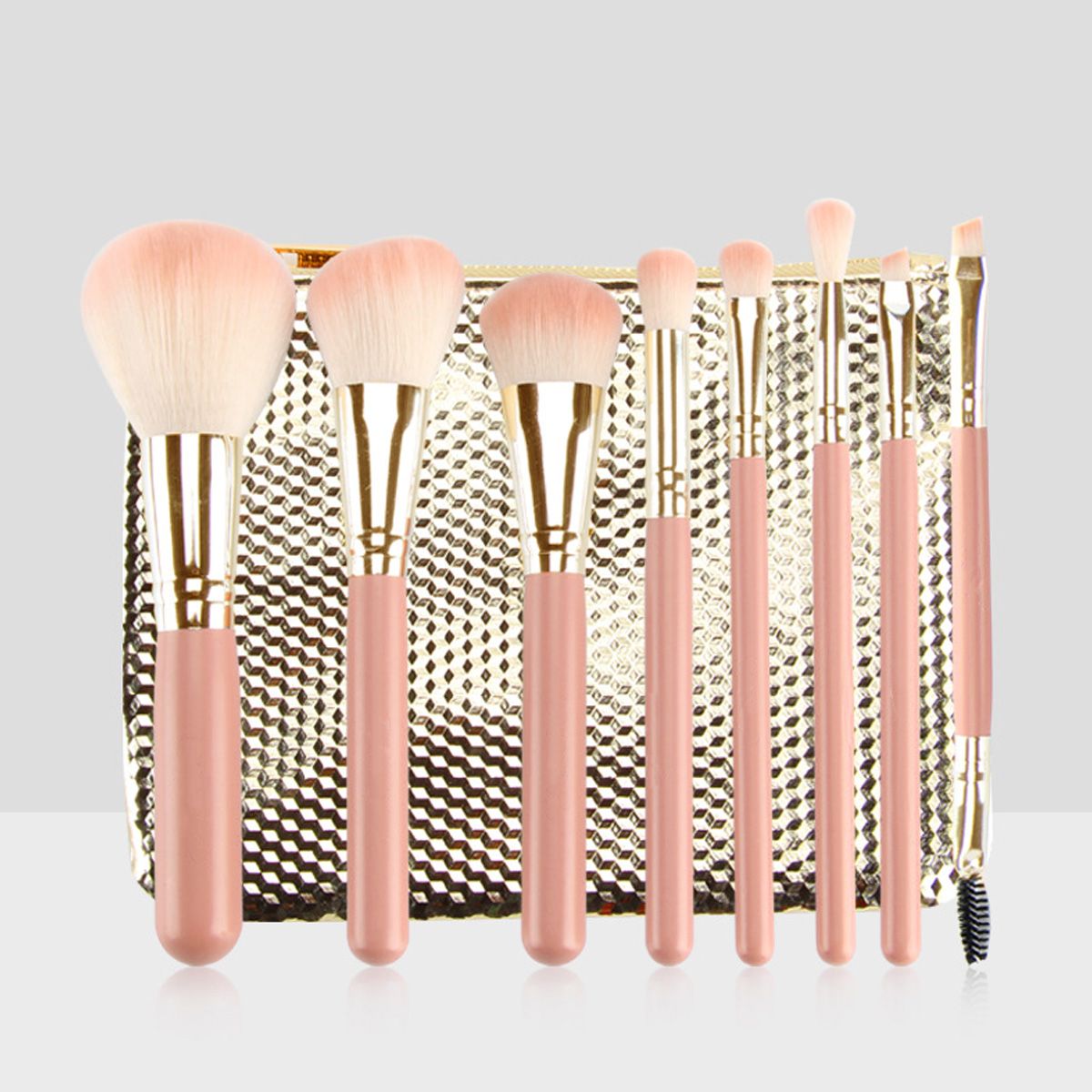 Set mit acht rosa Make-up-Pinseln mit goldenen Applikationen und einem goldenen Etui.