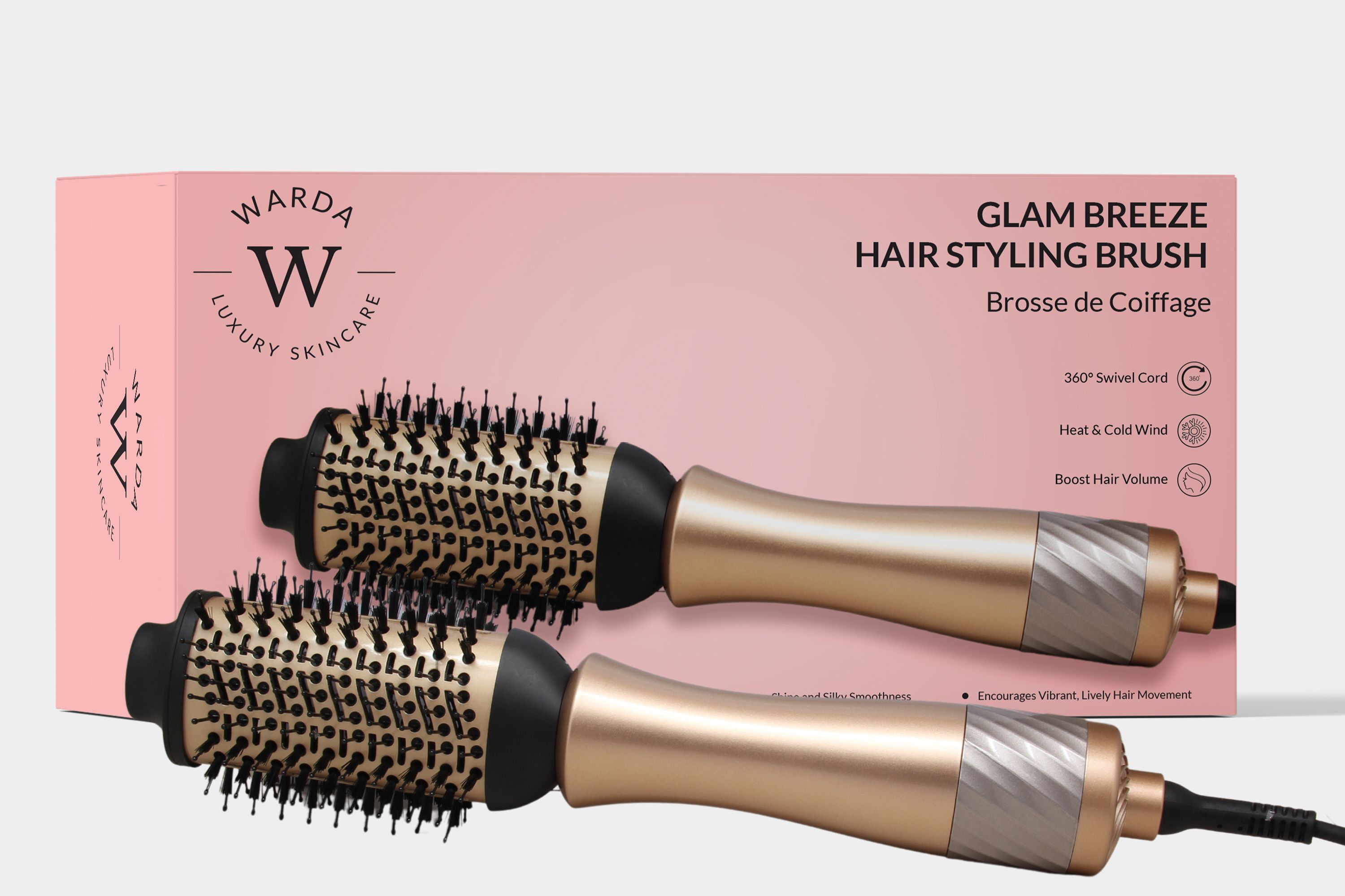 Haarstylingbürste mit goldfarbenem Griff und schwarzem Bürstenkopf. Auf rosa Verpackung mit Produktnamen und Logo.