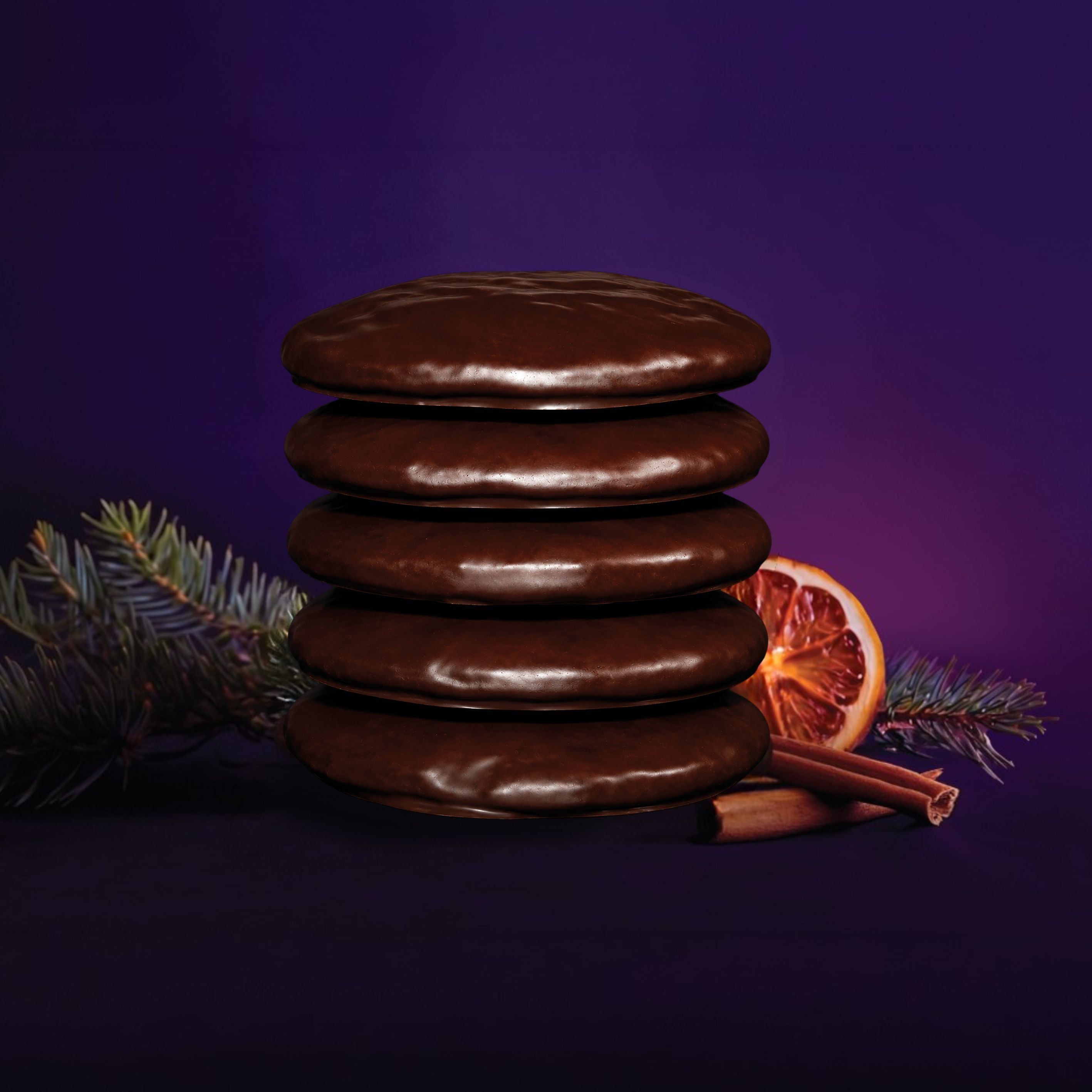 Stapel Odilia Bio Elisen Lebkuchen mit Schokoladenüberzug, Zimt, Orange und Tannenzweig.