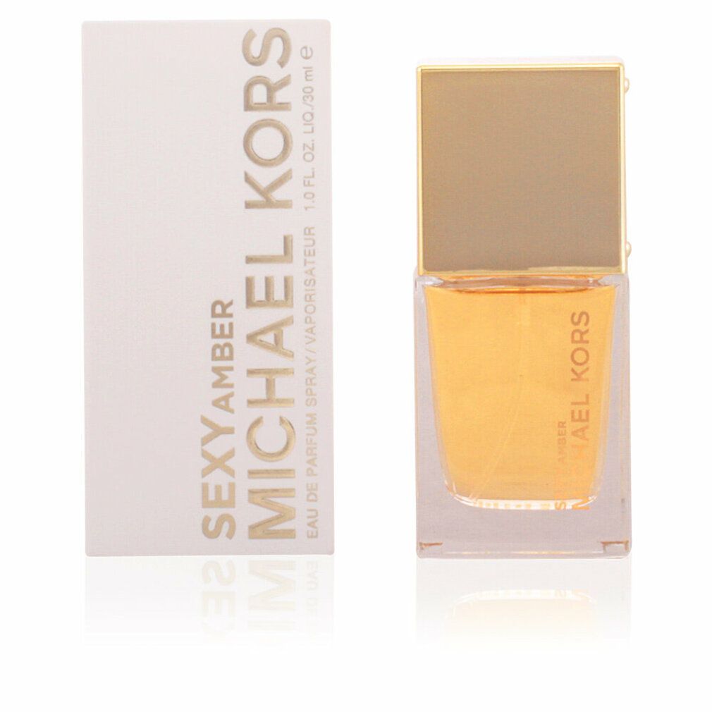 Parfümflasche und Verpackung. Aufschrift: MICHAEL KORS SEXY AMBER. Goldfarbene Schrift auf weißem Hintergrund. Flasche mit goldfarbenem Deckel.