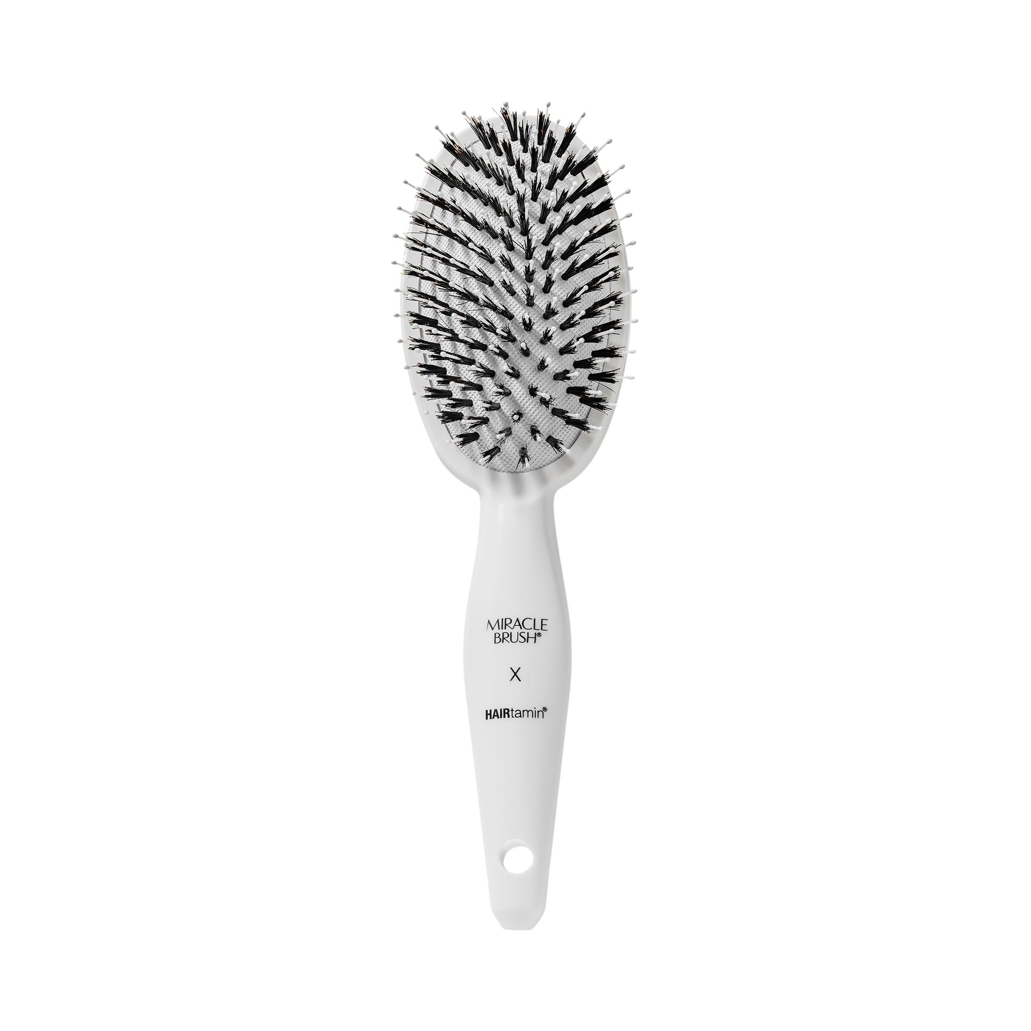 Weiße ovale Bürste mit schwarzen Borsten. Griff mit Schriftzug MIRACLE BRUSH X HAIRtamin.