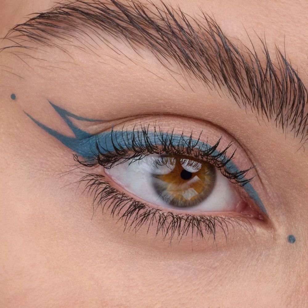 Auge mit blauem Eyeliner-Design. Zwei Punkte über dem Auge.