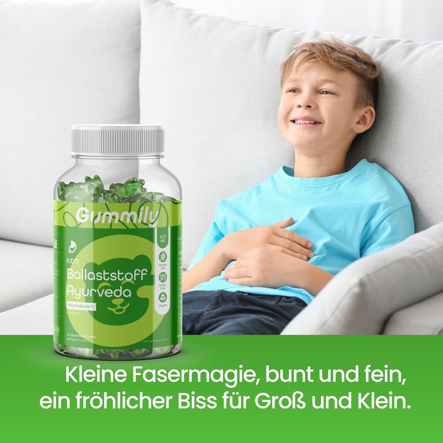 Junge lächelt neben einem Behälter Gummily Tummy Gummibärchen mit Ballaststoffen.