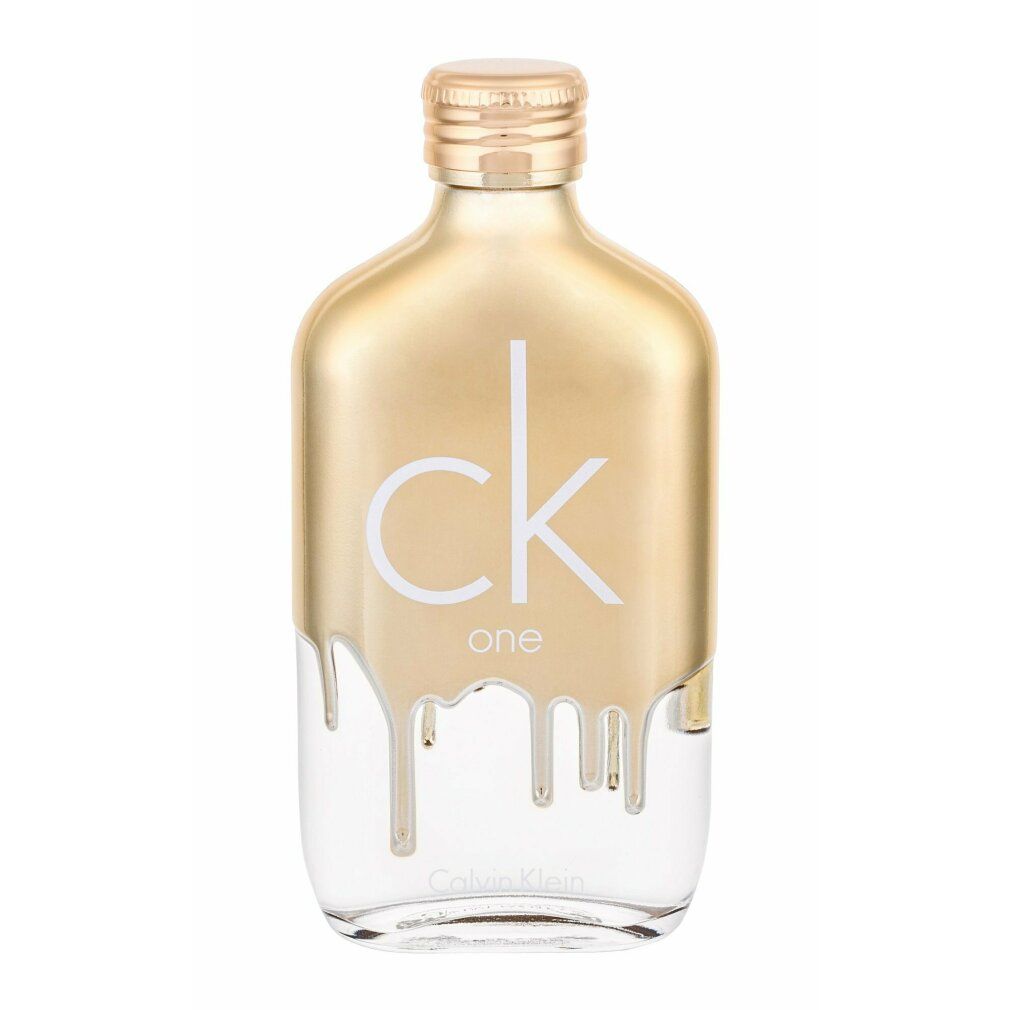 Goldfarbener Flakon mit weißem Schriftzug „ck one“. Unterer Teil transparent. Tropfendes Design. Calvin Klein Logo.