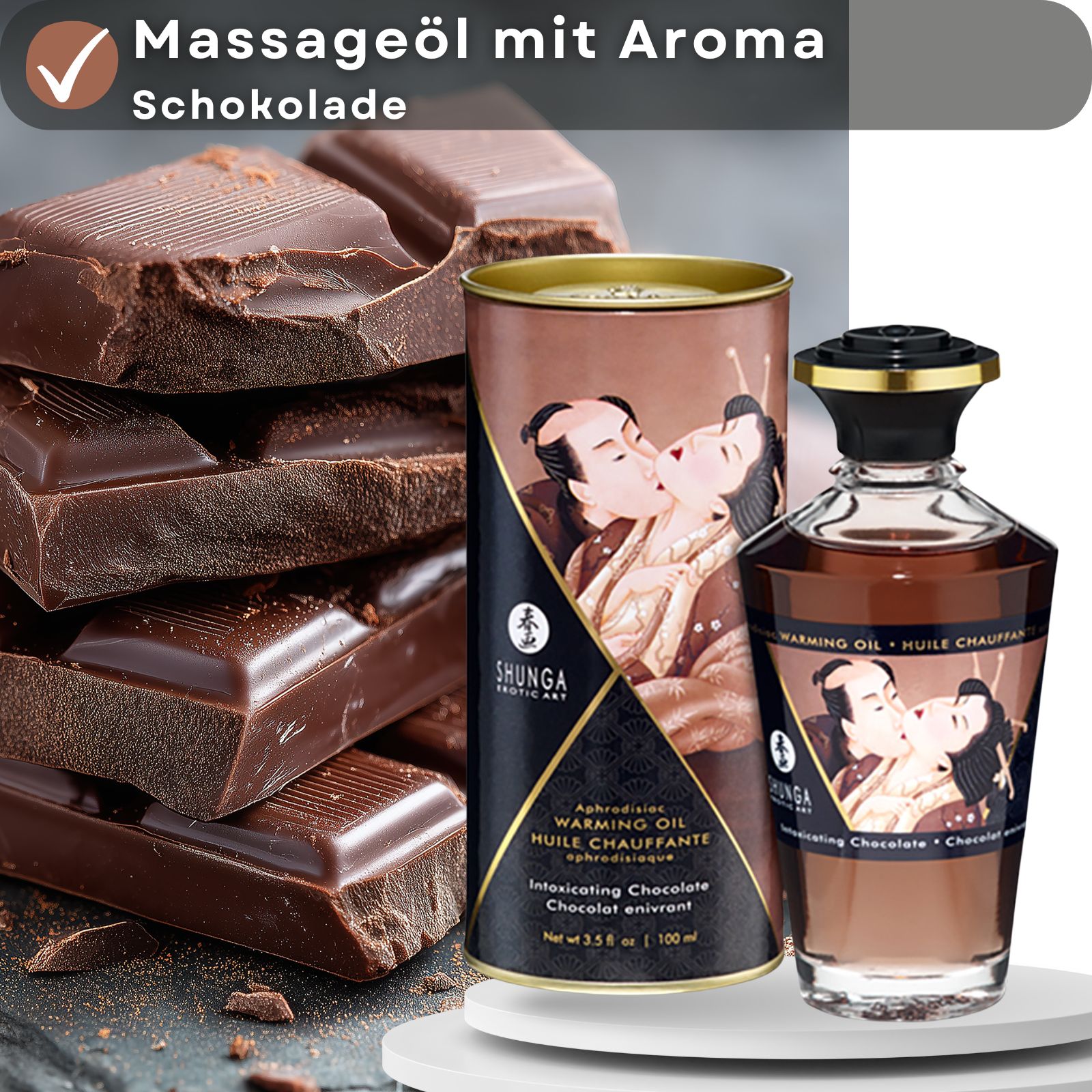 Massageöl mit Aroma Schokolade von Shunga. Flasche und Verpackung neben Schokoladenstücken. Text: Warming Oil, Intoxicating Chocolate.