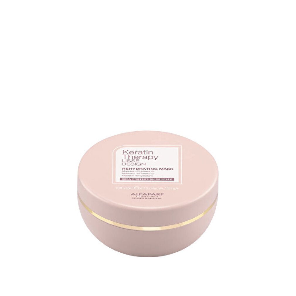 Runder, blassrosa Behälter mit goldfarbenem Band. Etikett mit 'Keratin Therapy Lisse Design Rehydrating Mask'.
