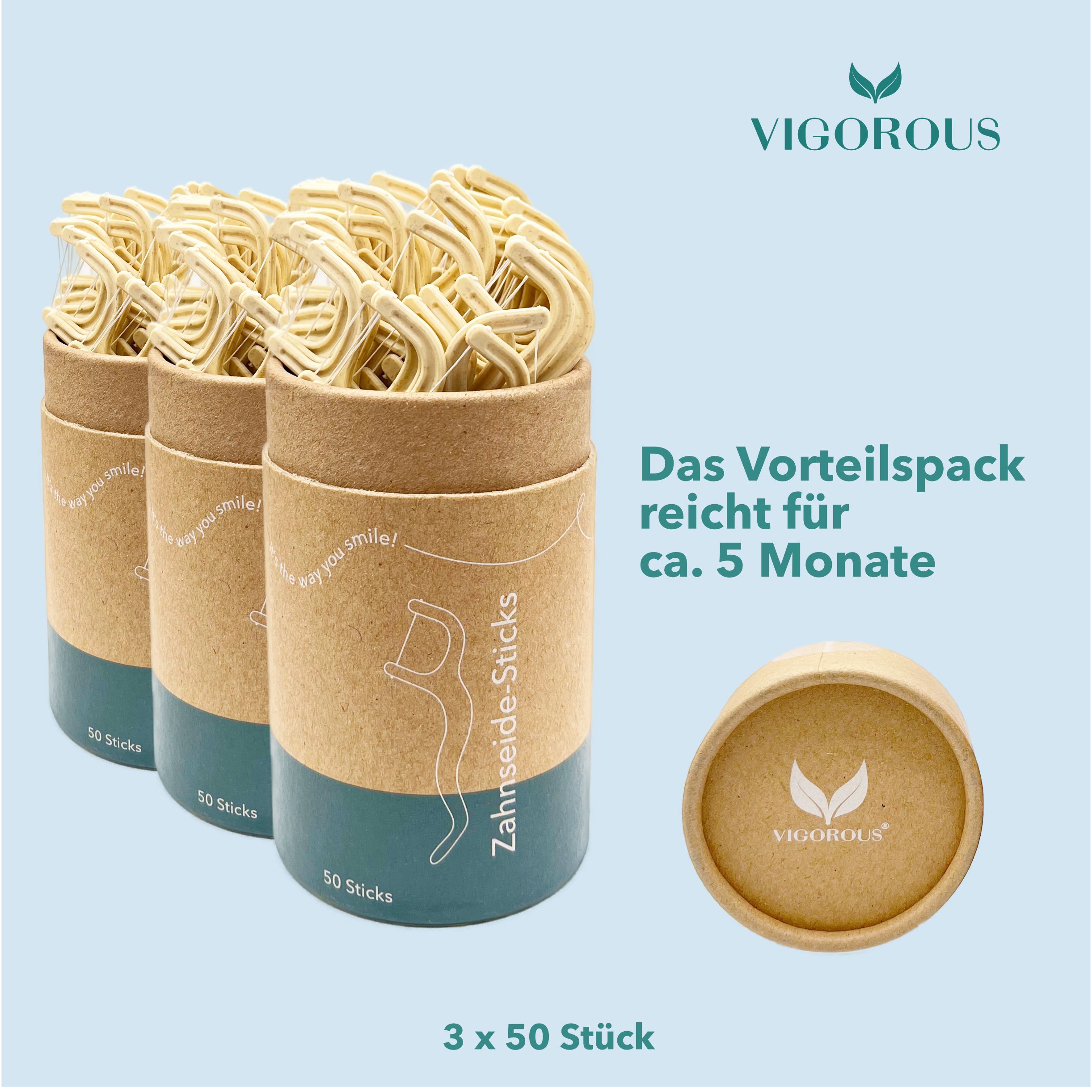 Drei Behälter mit Zahnseide-Sticks, geöffnet. Aufschrift: VIGOROUS. Text: Das Vorteilspack reicht für ca. 5 Monate. 3 x 50 Stück.