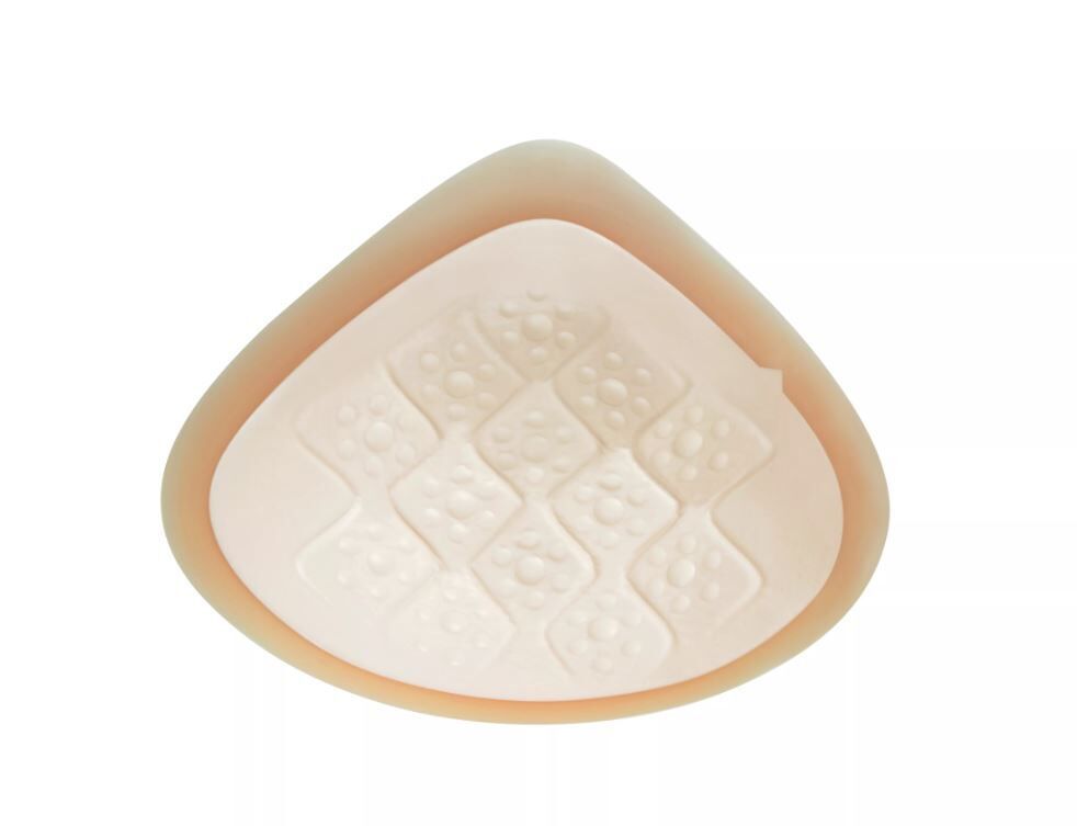 Beige Ausgleichsepithese. Dreieckige Form mit quadratischem Muster auf der Oberfläche.