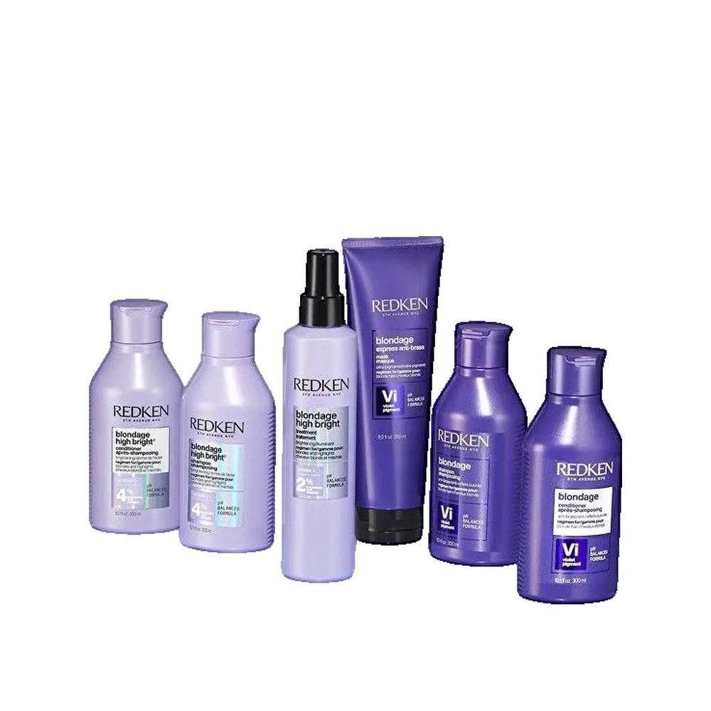 Mehrere Redken Blondage High Bright Produkte. Flaschen und Tuben in Lila. Text: Blondage High Bright, Vitamin C, 2% und 4%, pH-ausgewogene Formel.