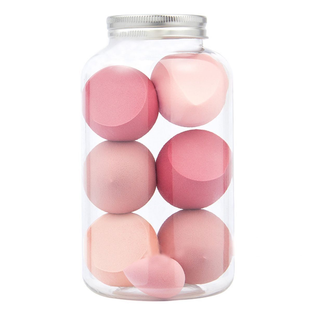 Make-up-Schwämme in einer transparenten Dose mit silbernem Deckel. Verschiedene rosa Farbtöne und Formen.