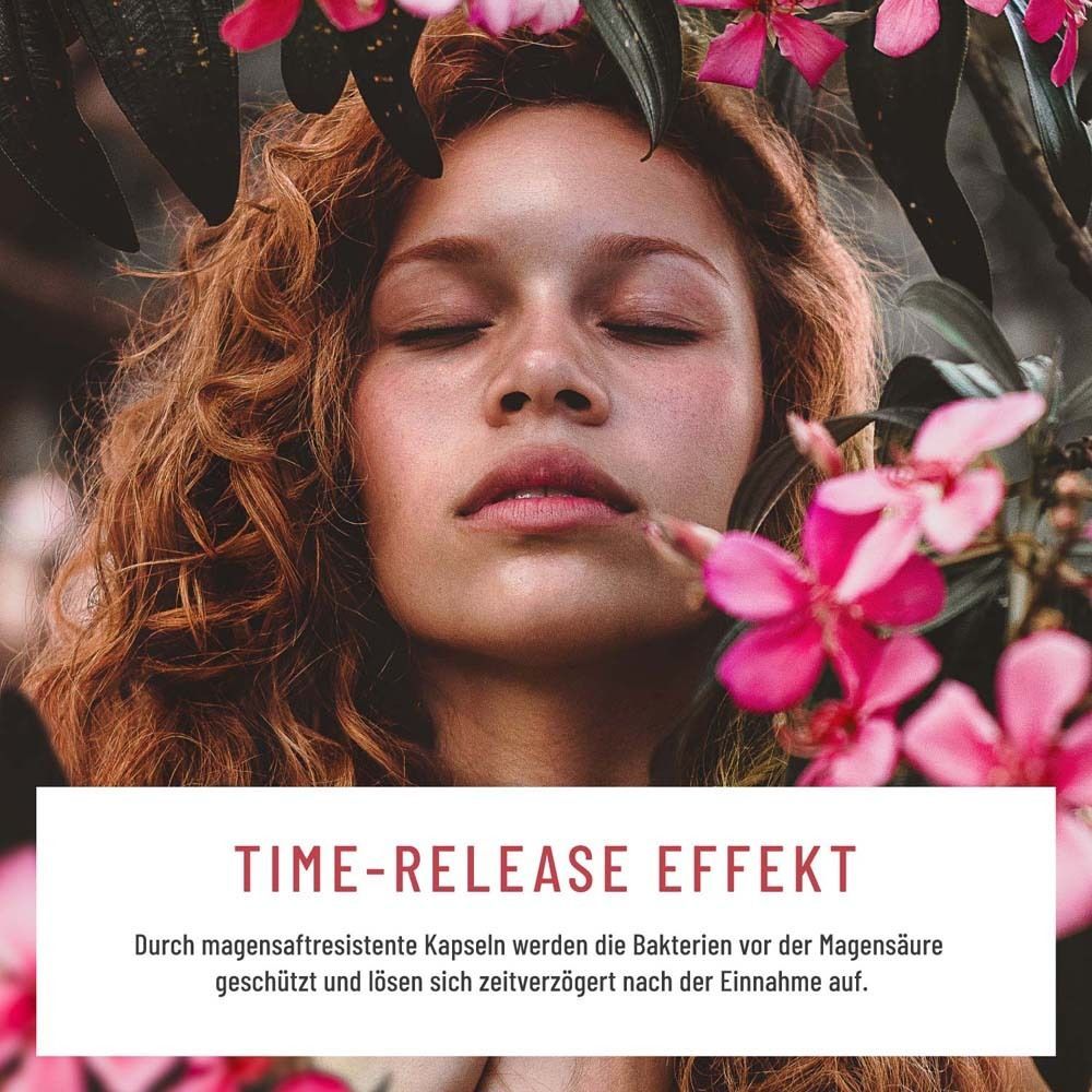 Frau mit geschlossenen Augen, umgeben von rosa Blüten. Text: Time-Release Effekt. Kapseln schützen vor Magensäure.