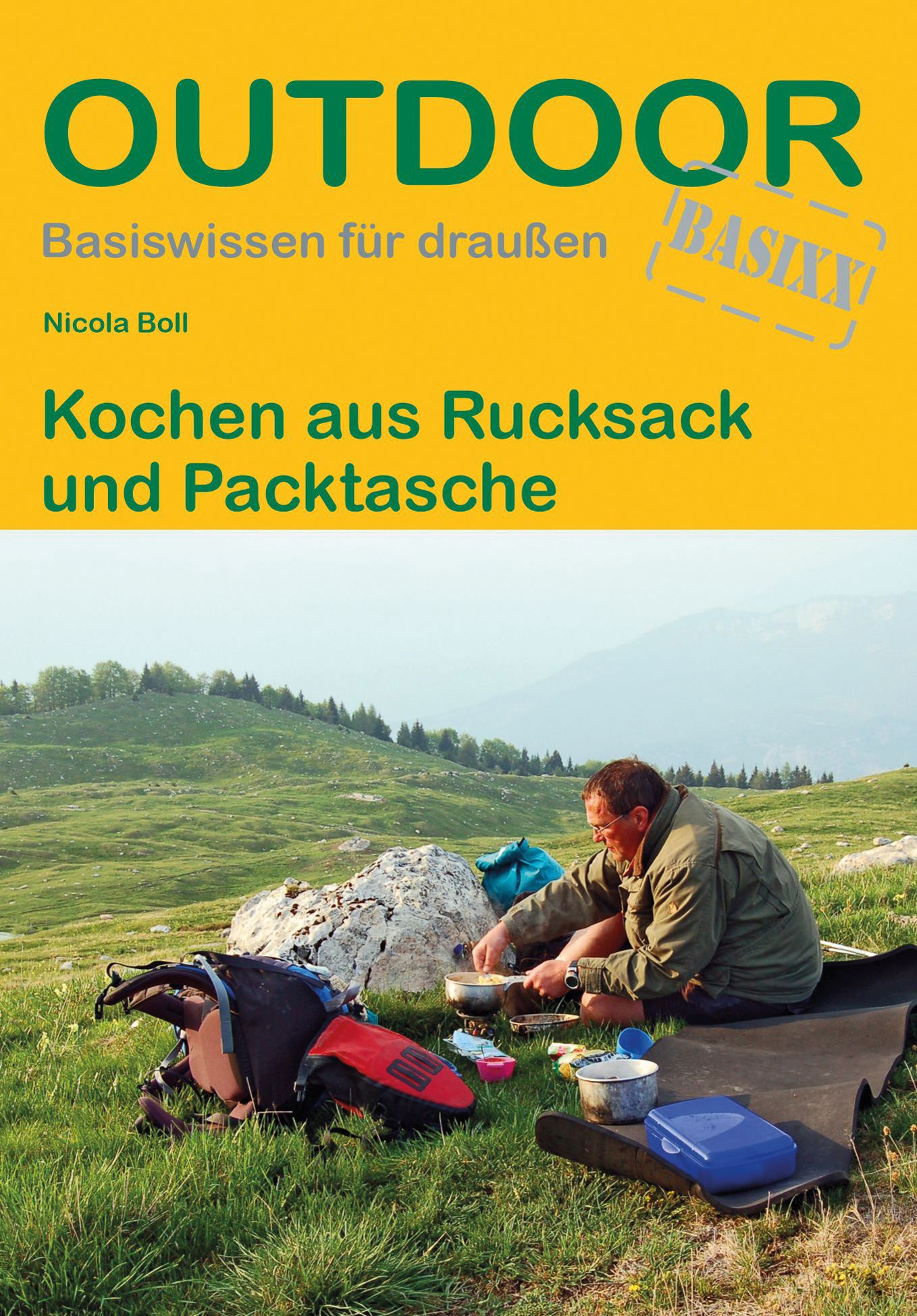 Buchcover: "Outdoor" mit Titel und Autor. Mann kocht am Berg. Rucksack und Kochutensilien liegen bereit.
