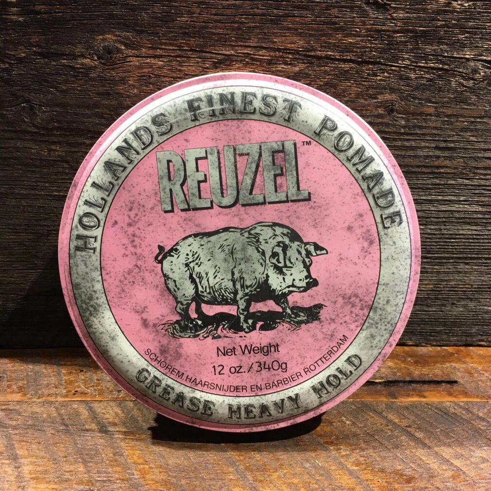 Reuzel Pink Pomade Dose mit Schwein-Logo auf Holzhintergrund.