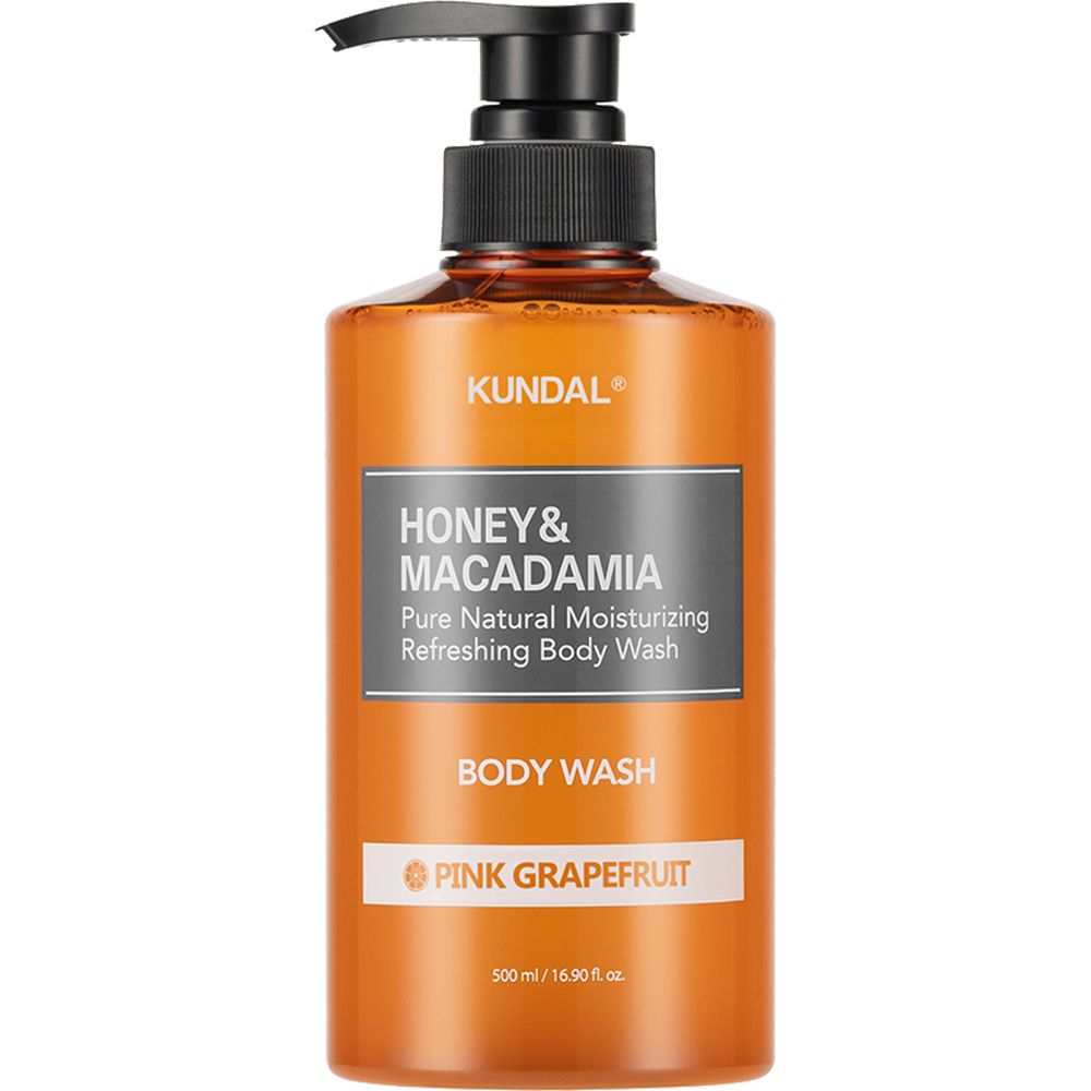 Orangefarbene Flasche mit schwarzem Pumpverschluss. Aufschrift: KUNDAL, HONEY & MACADAMIA, BODY WASH, PINK GRAPEFRUIT.