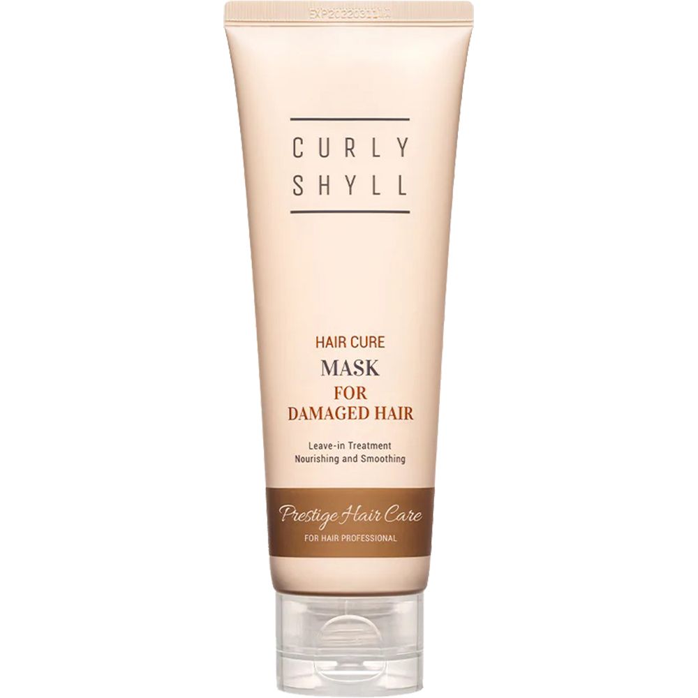 Beige Tube mit Schriftzug CURLY SHYLL. Text: Hair Cure Mask for Damaged Hair. Leave-in Treatment. Prestige Hair Care.